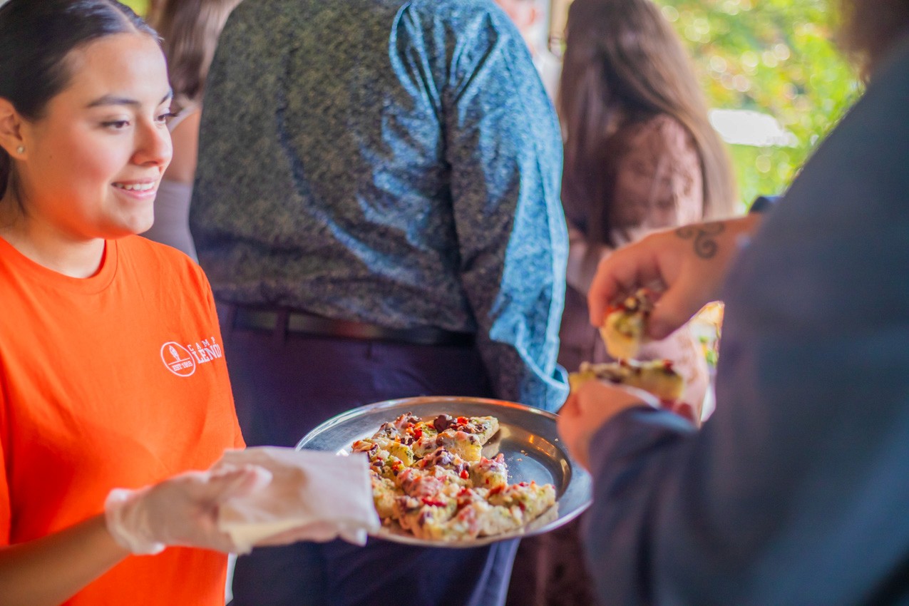 Camp Lenox staff member serving nachos at an event