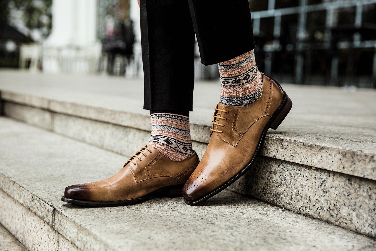 Two men talking, one wears a veteran hat.