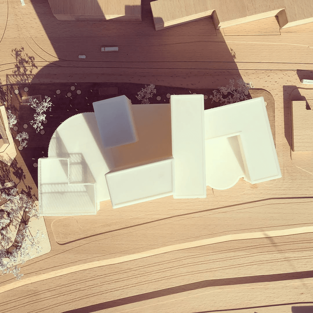 Wooden base with white 3d printed building shoot take from above