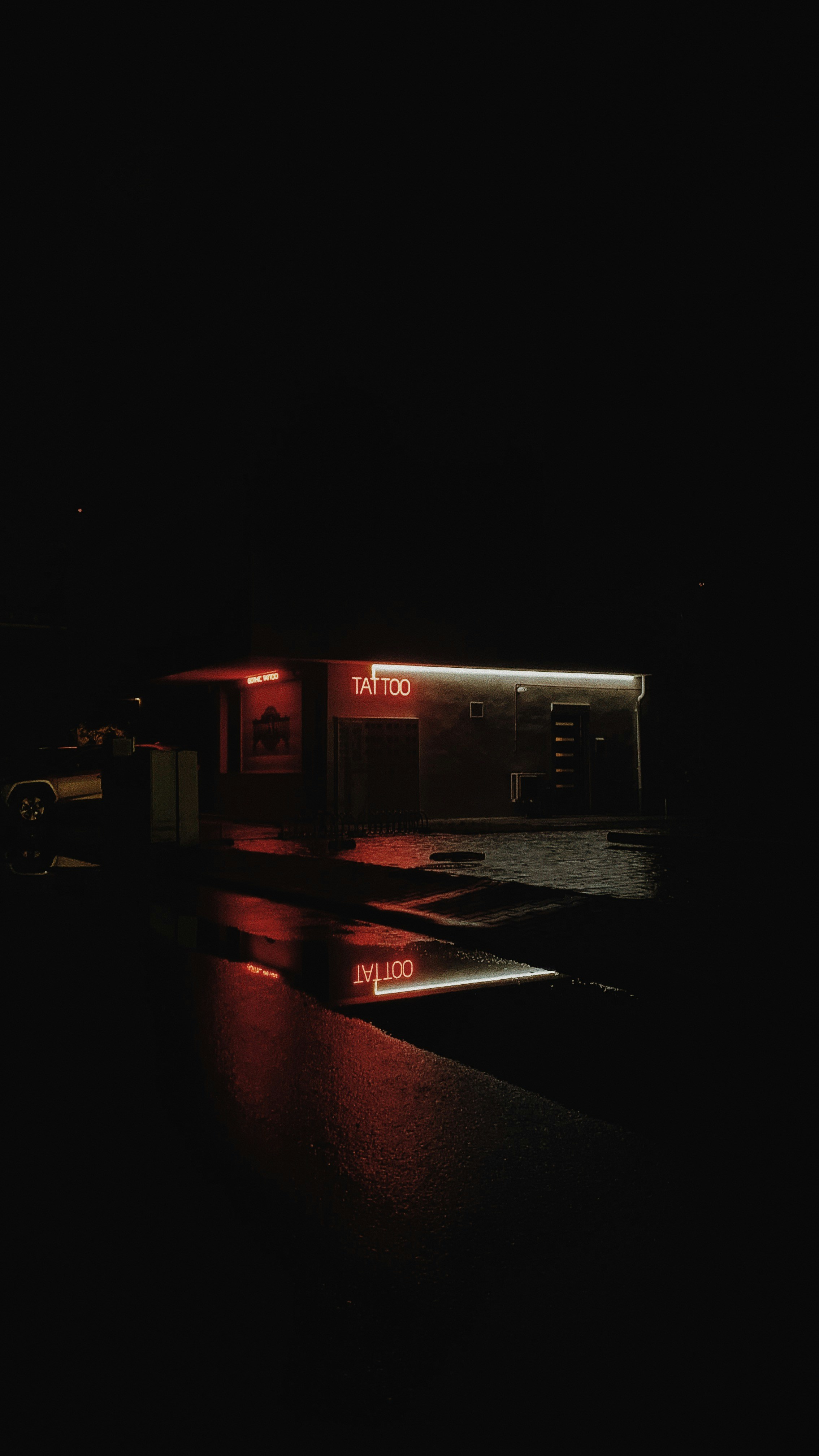 a gas station lit up at night with a red light