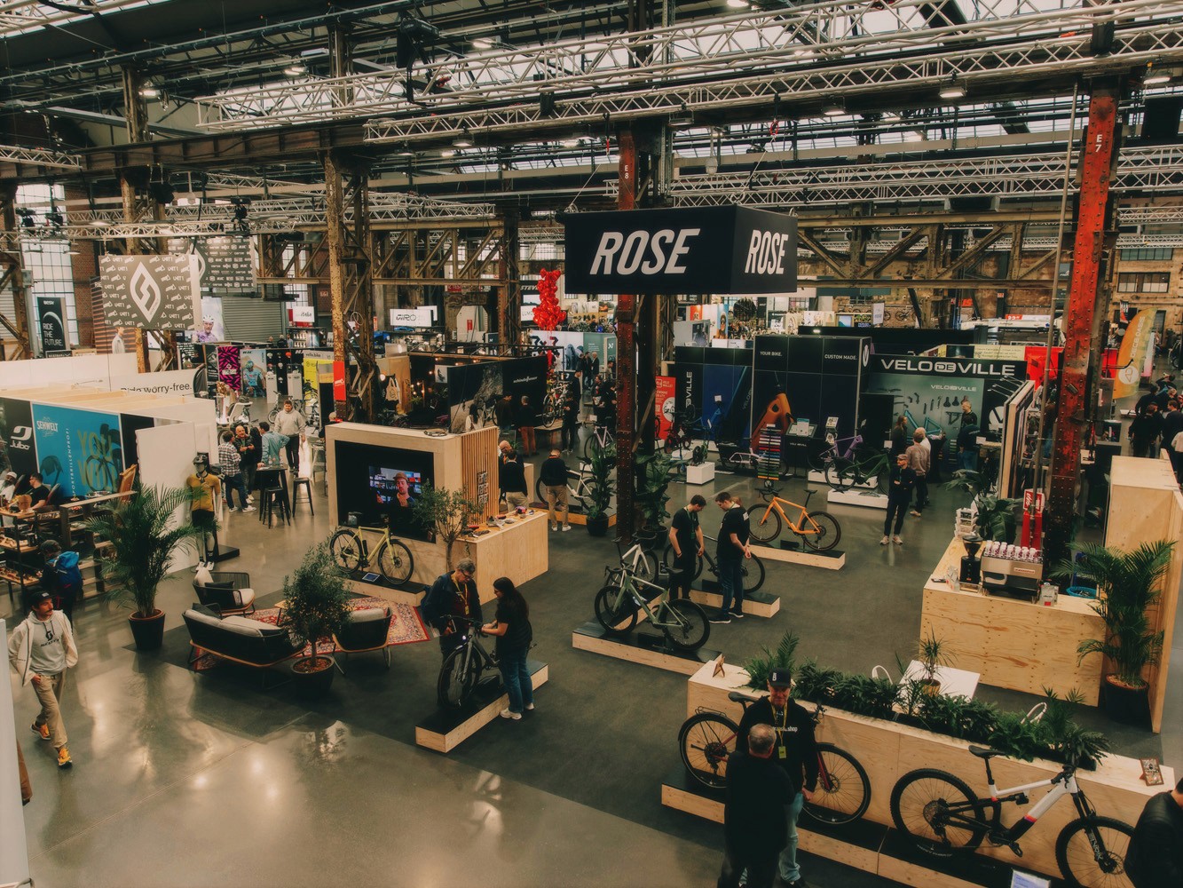 A smiling woman writing on a piece of paper in her home