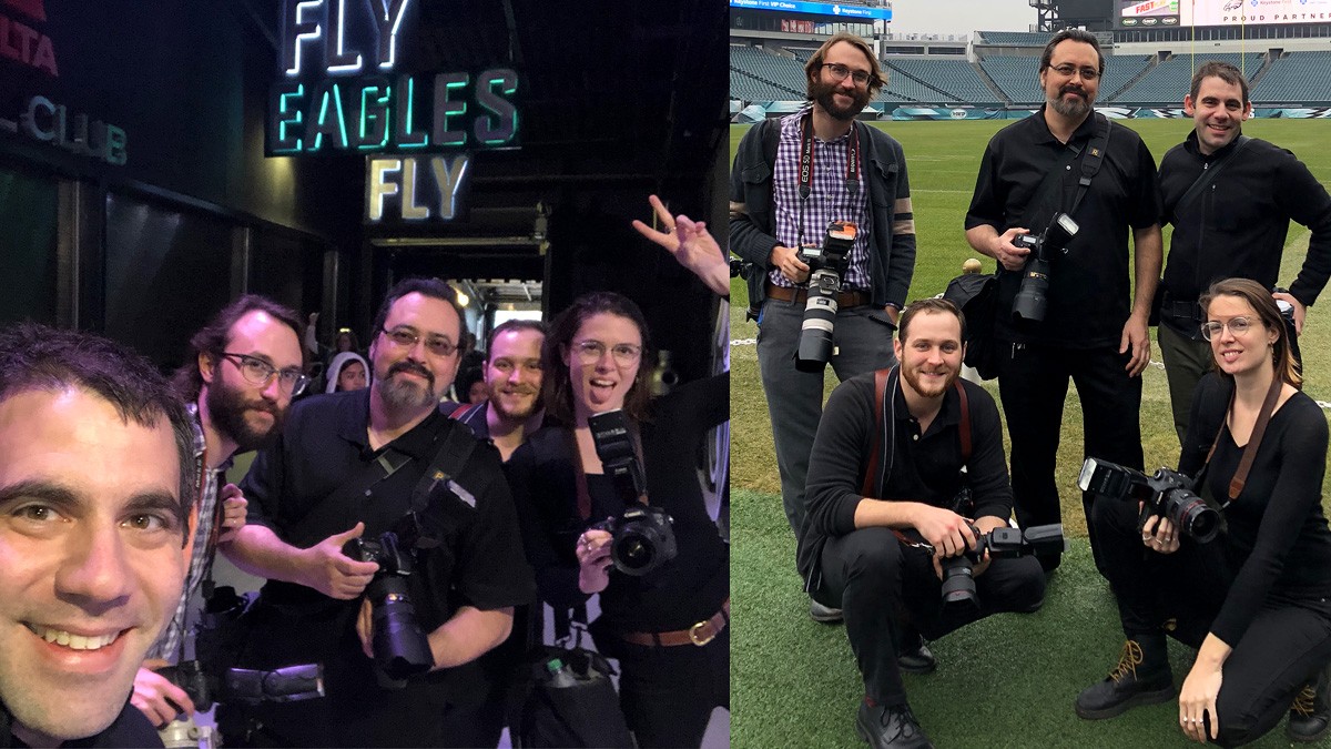 Photographers standing in empty football stadium.
