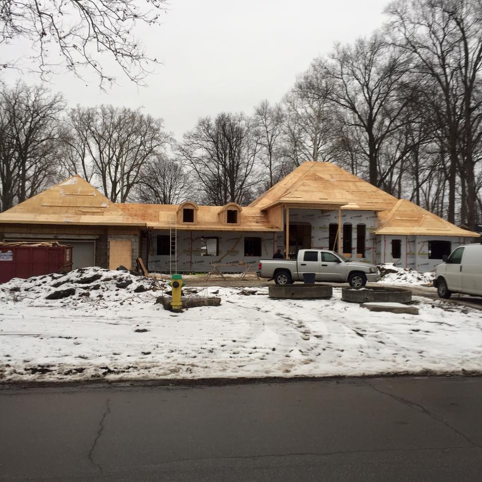 a man in a yellow shirt is working on a roof