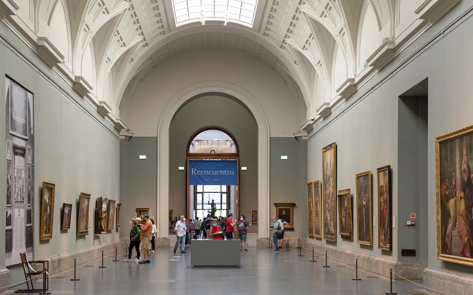Tourists viewing paintings inside Prado Museum, Madrid.