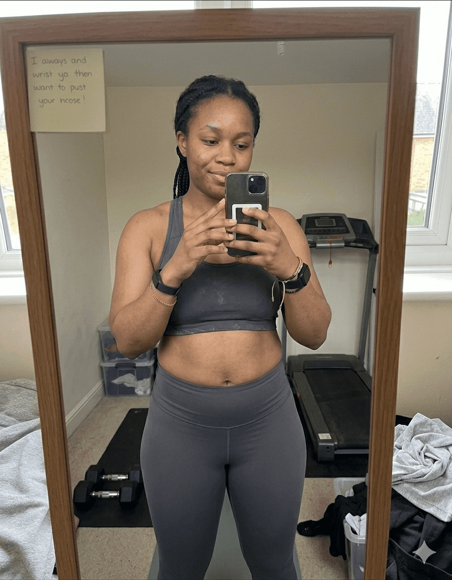 Chloe before fitness transformation – mirror selfie in sports bra and grey leggings showing starting physique