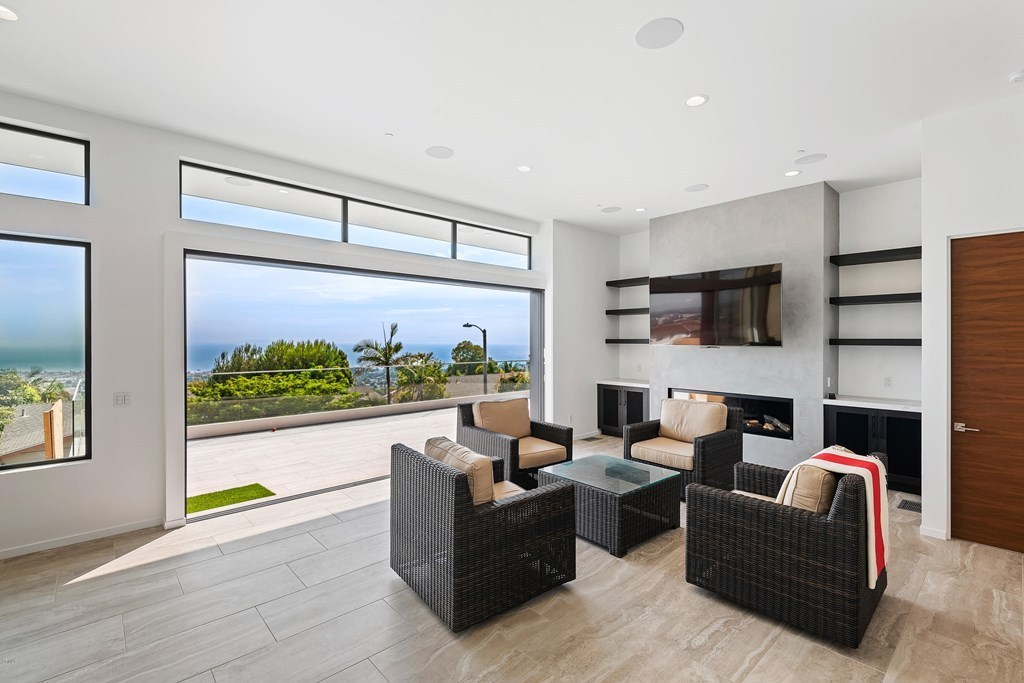 Living room with pocketing open slider doors creating a seamless transition to the outdoors.