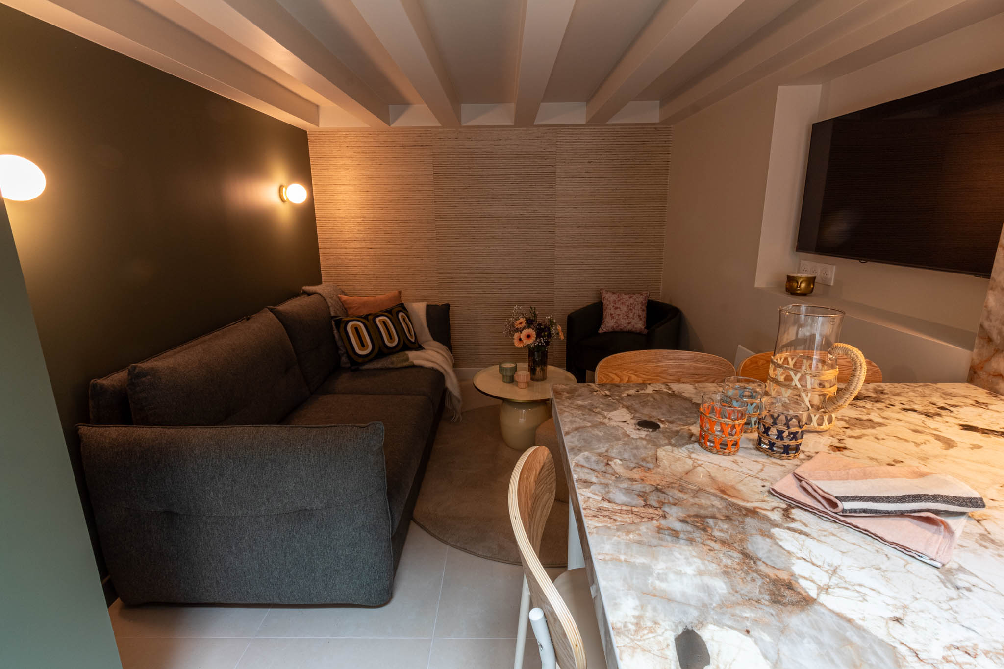 A white theme bedroom with lamps desk and chair