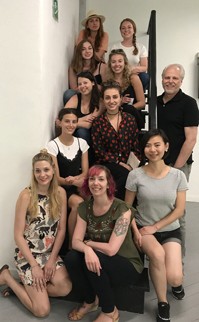 A photo of a group of people sitting on a staircase.