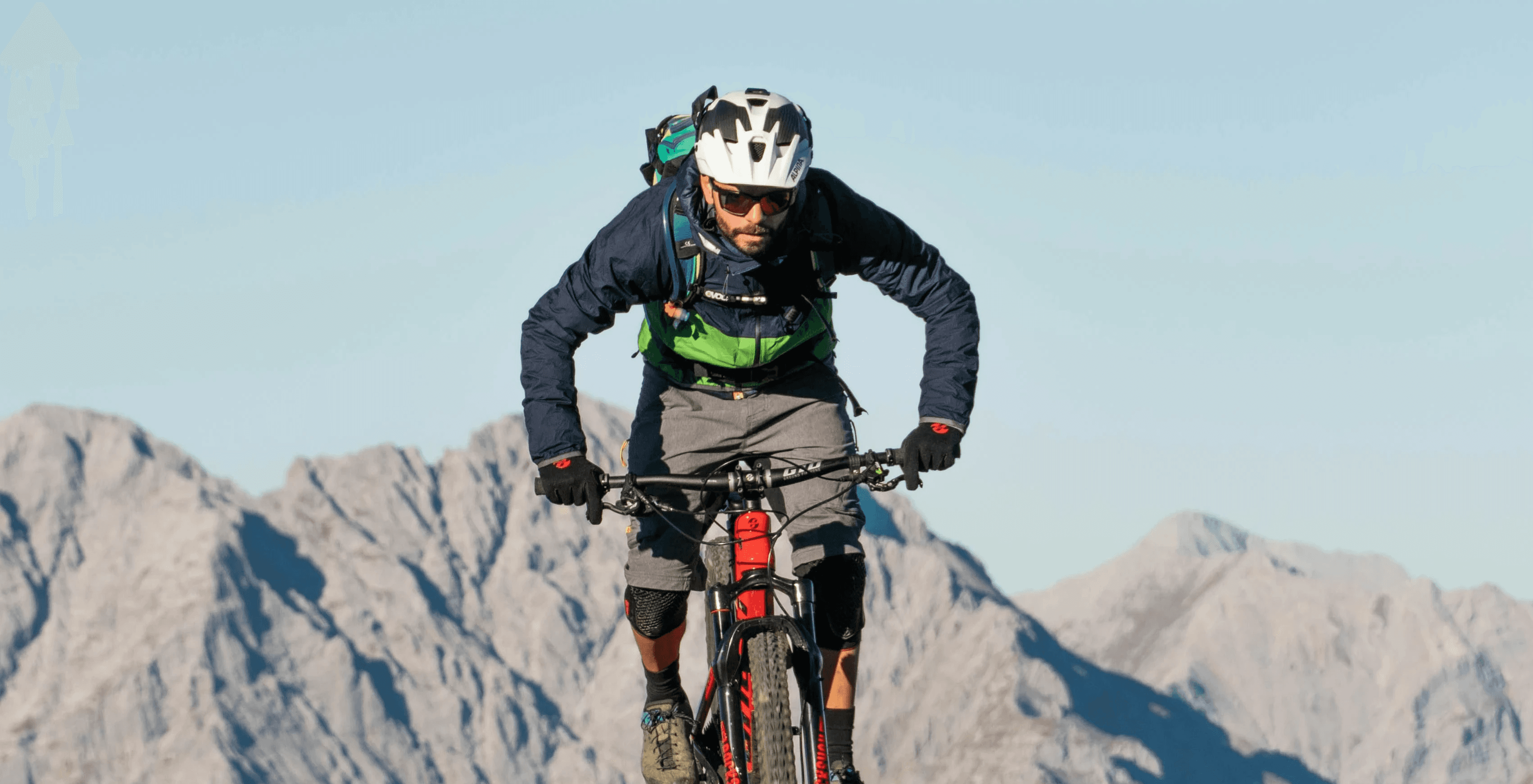 a man riding a bike on a mountain