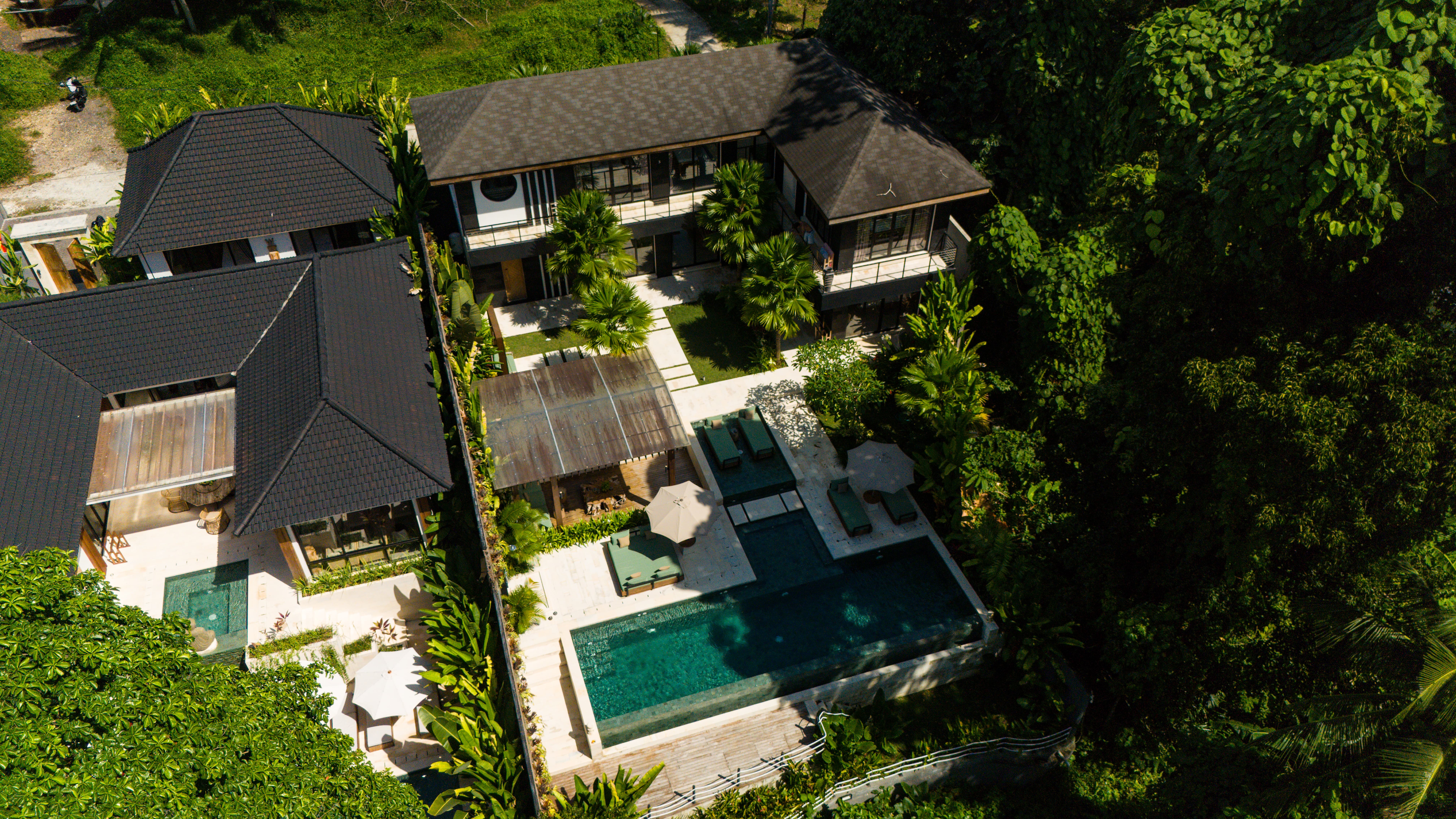 woman in brown long-sleeved top standing beside wall