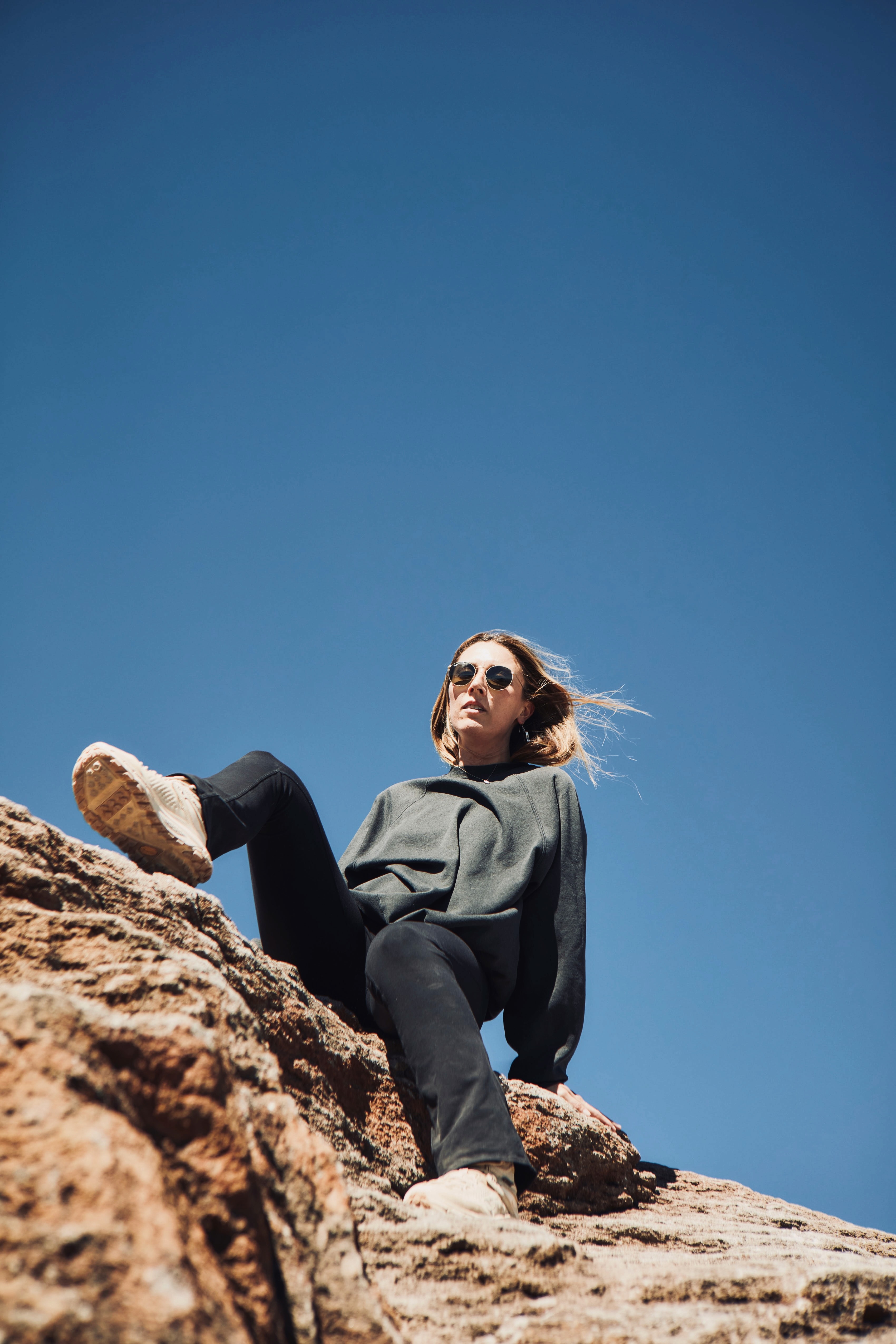 Person sitting on a ledge overlooking New York City skyline