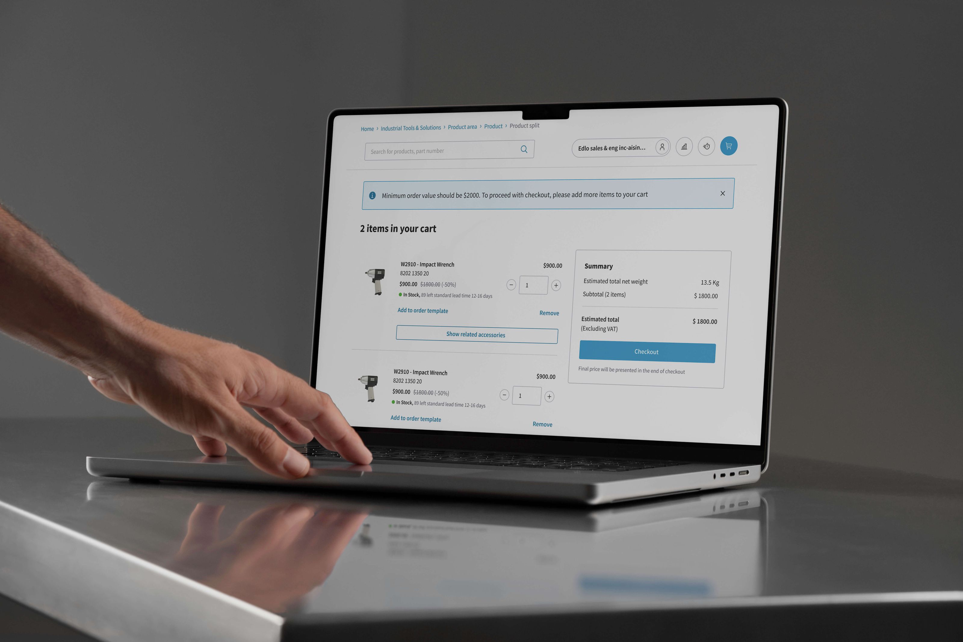 A hand toucing a laptop while screen showing UI