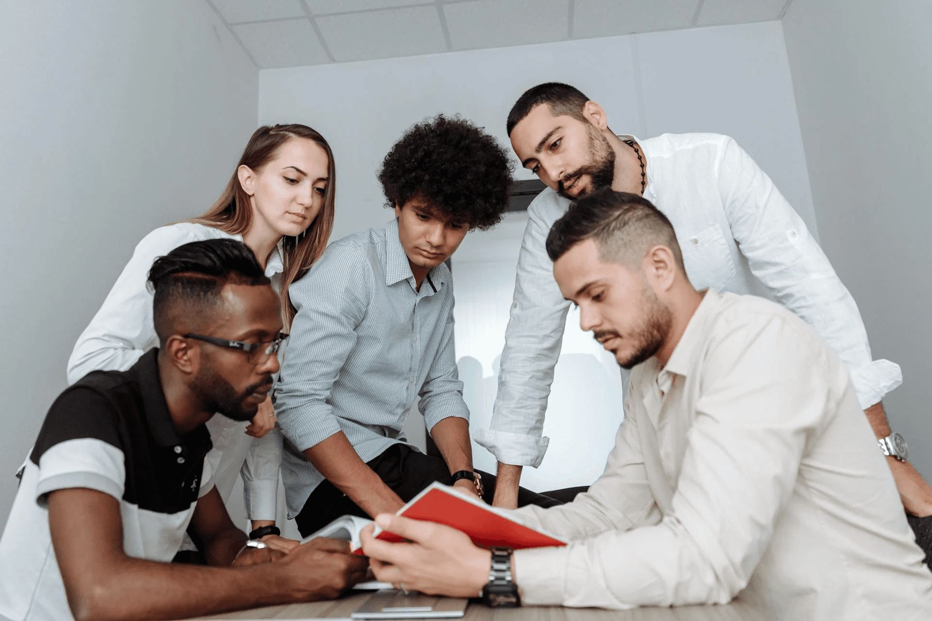 People looking at a paper together.