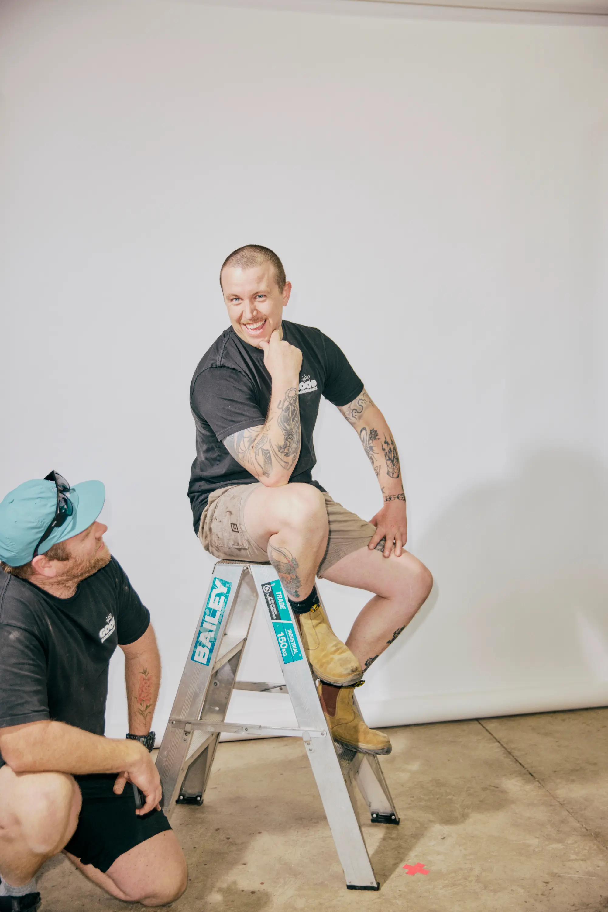 Good Maintenance Team Members posing on ladder