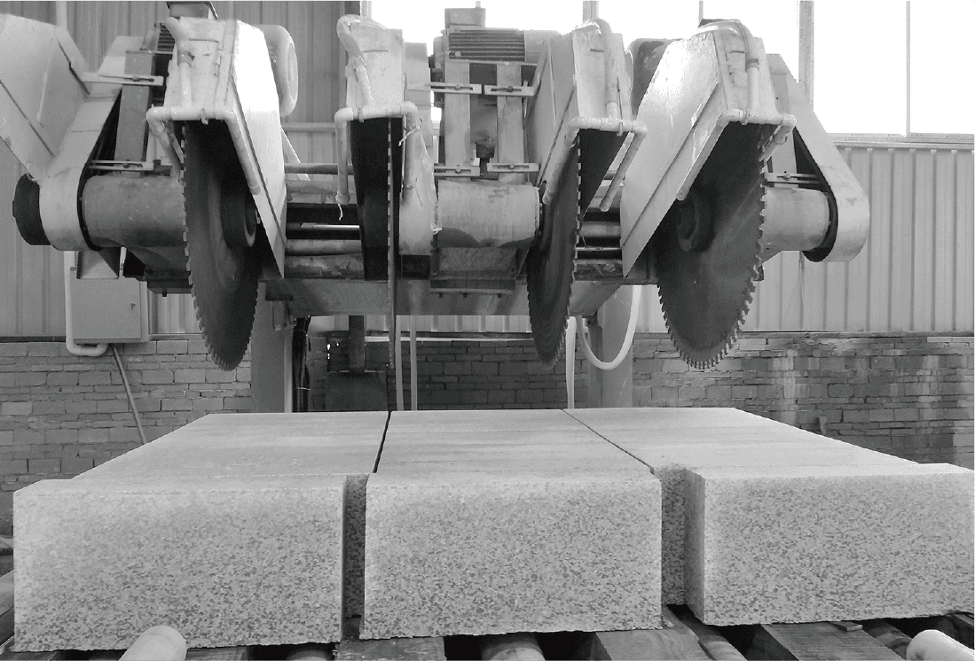 Close-up view of Dinosaw Kerbstone Cutting Machine's blades, demonstrating its capacity to cut multiple stone slabs at once for increased productivity.