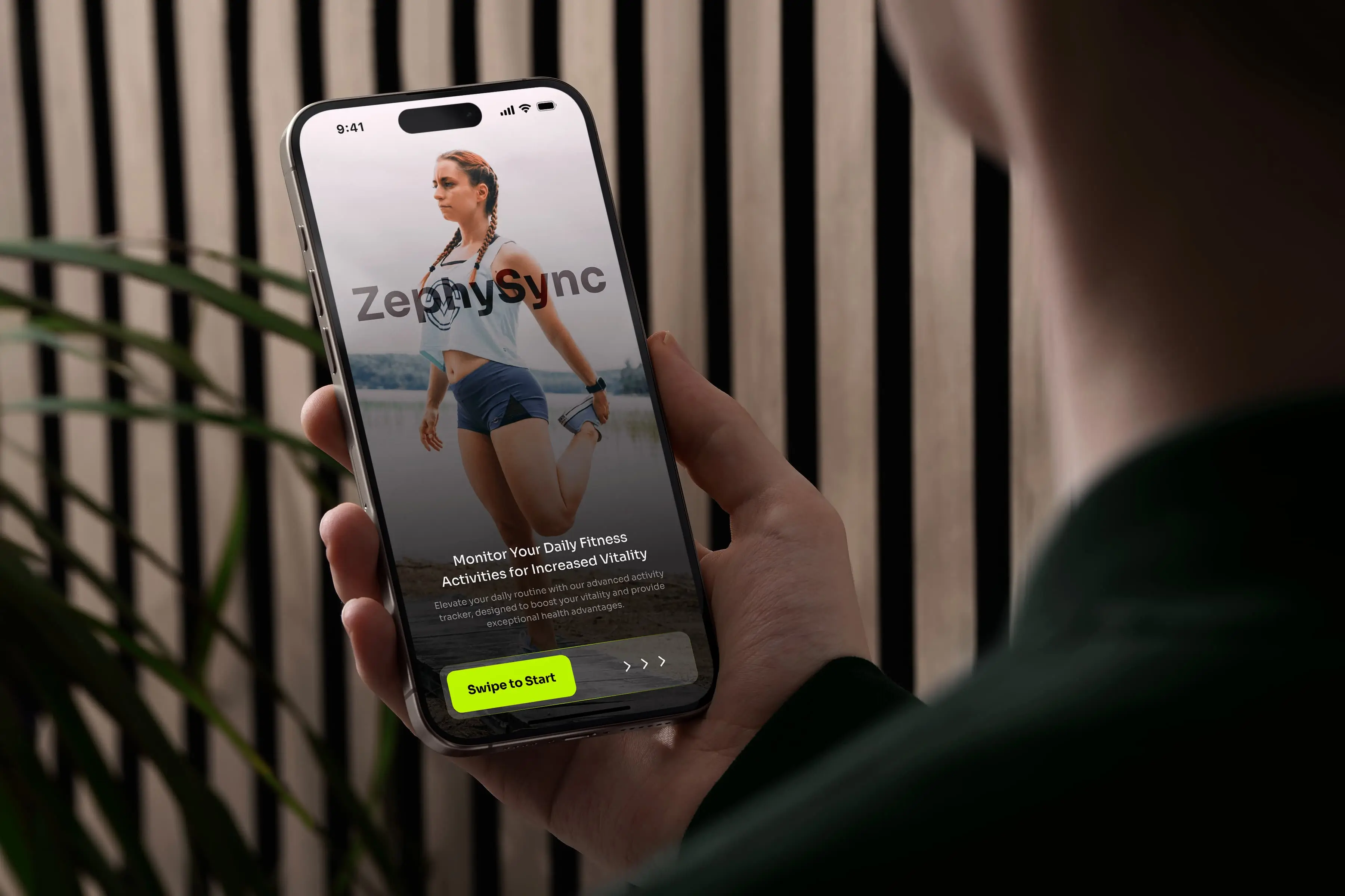 A man holding an iPhone running the ZephySync mobile app