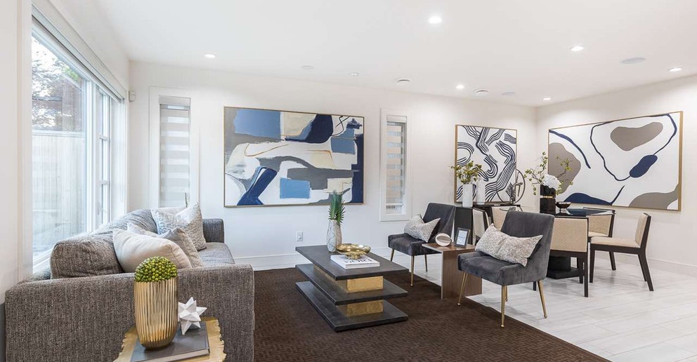 A modern living space featuring white walls, stylish furniture, and artwork. Bright and airy atmosphere.