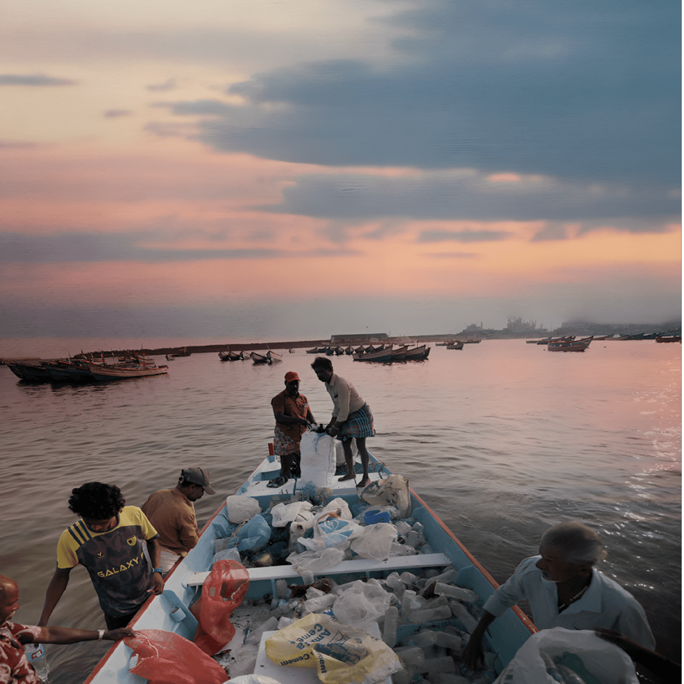 Woman in red outfit poses by a red telephone booth.
