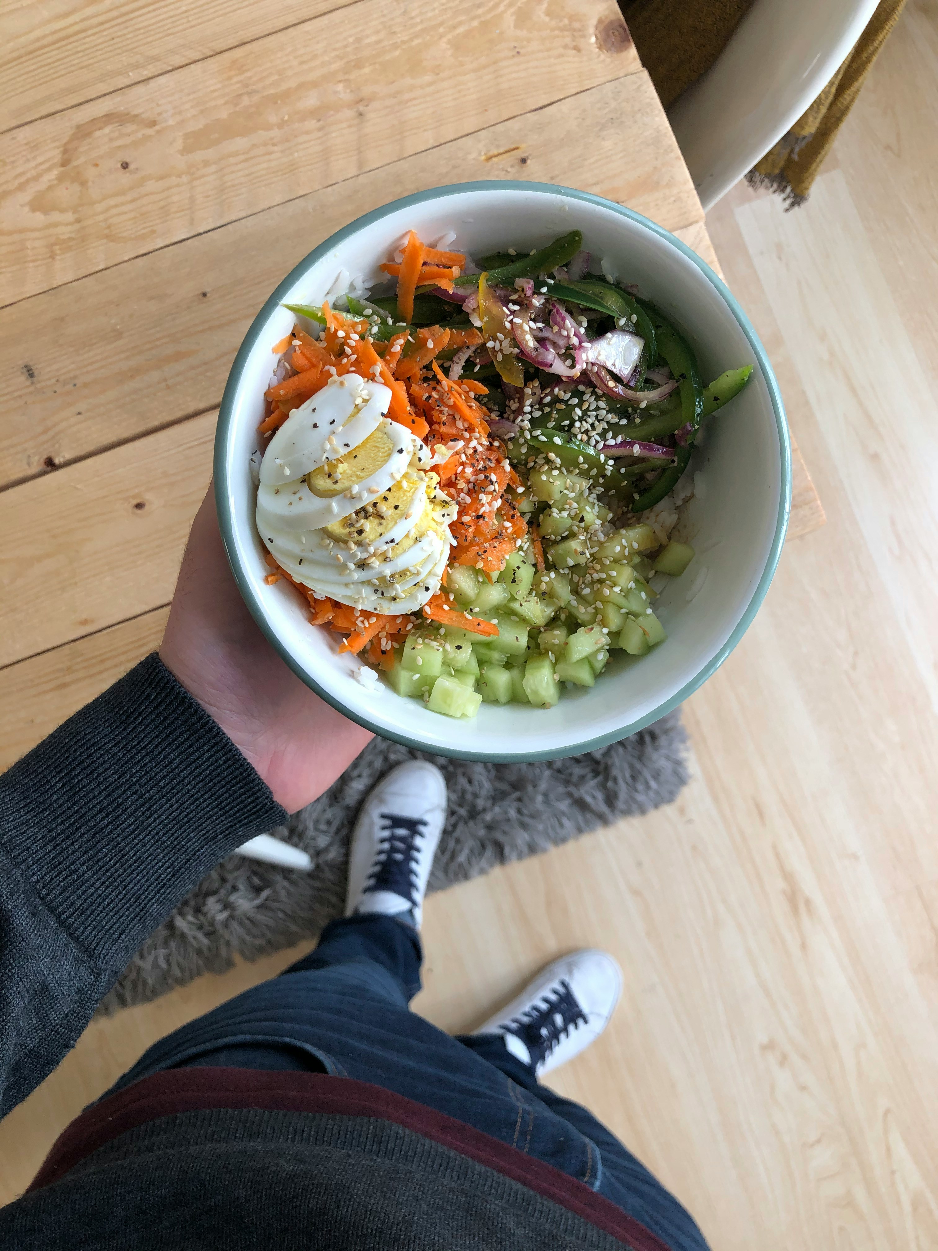 person holding white ceramic bowl with vegetable salad