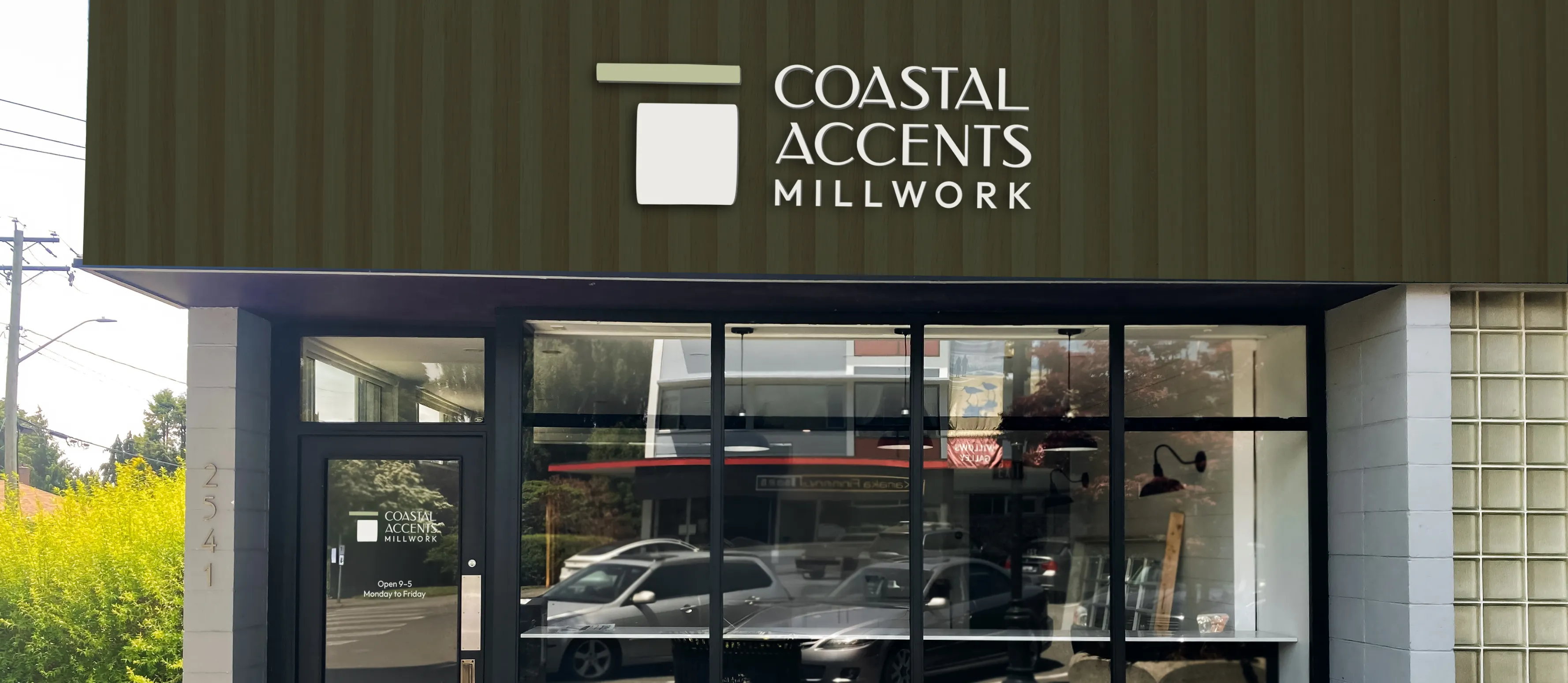 The coastal Accents Millwork logo mocked up on a storefront.