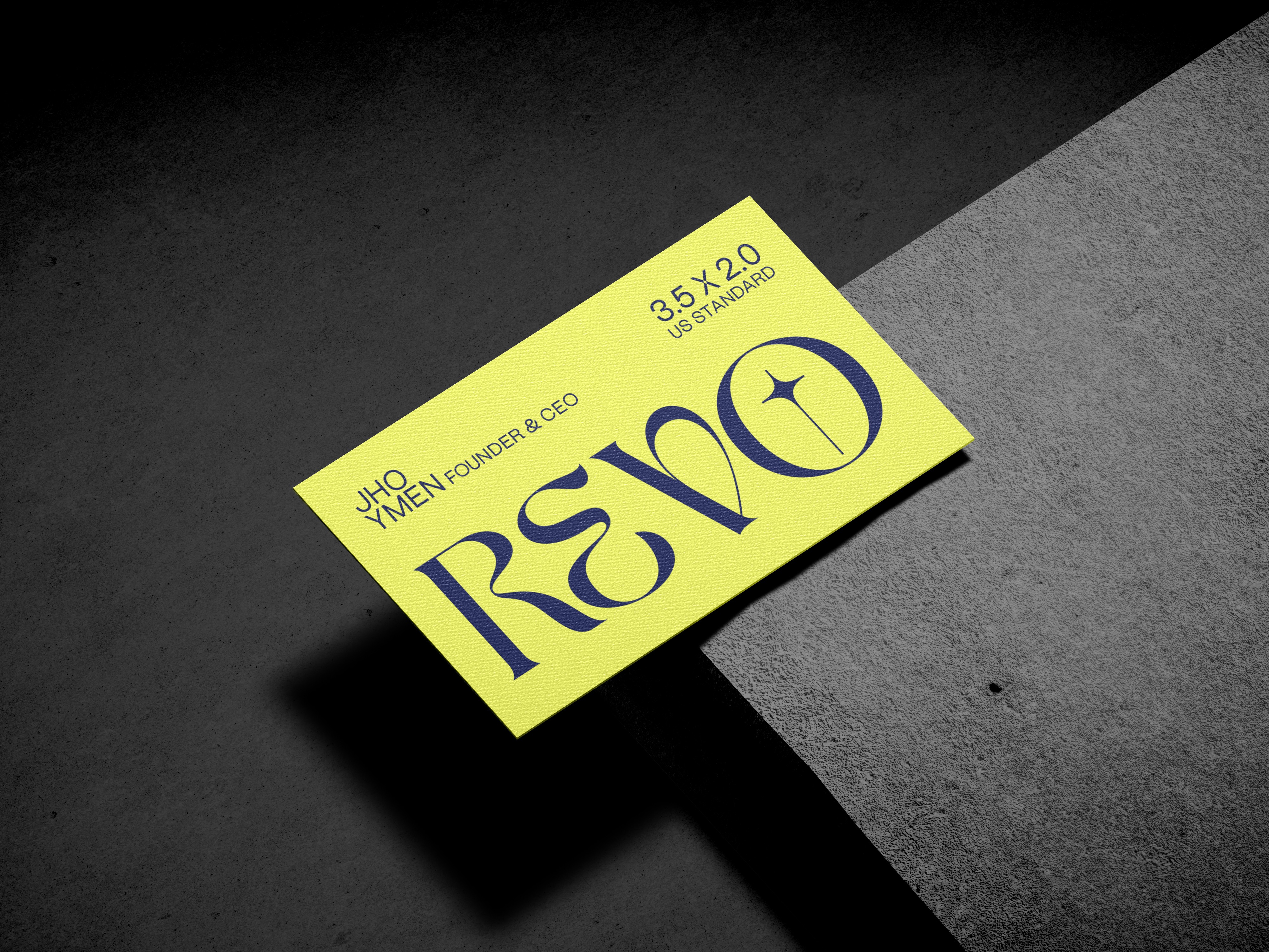 Close-up of a "REVO" branded card or logo design, showcased in a sophisticated black and white composition.