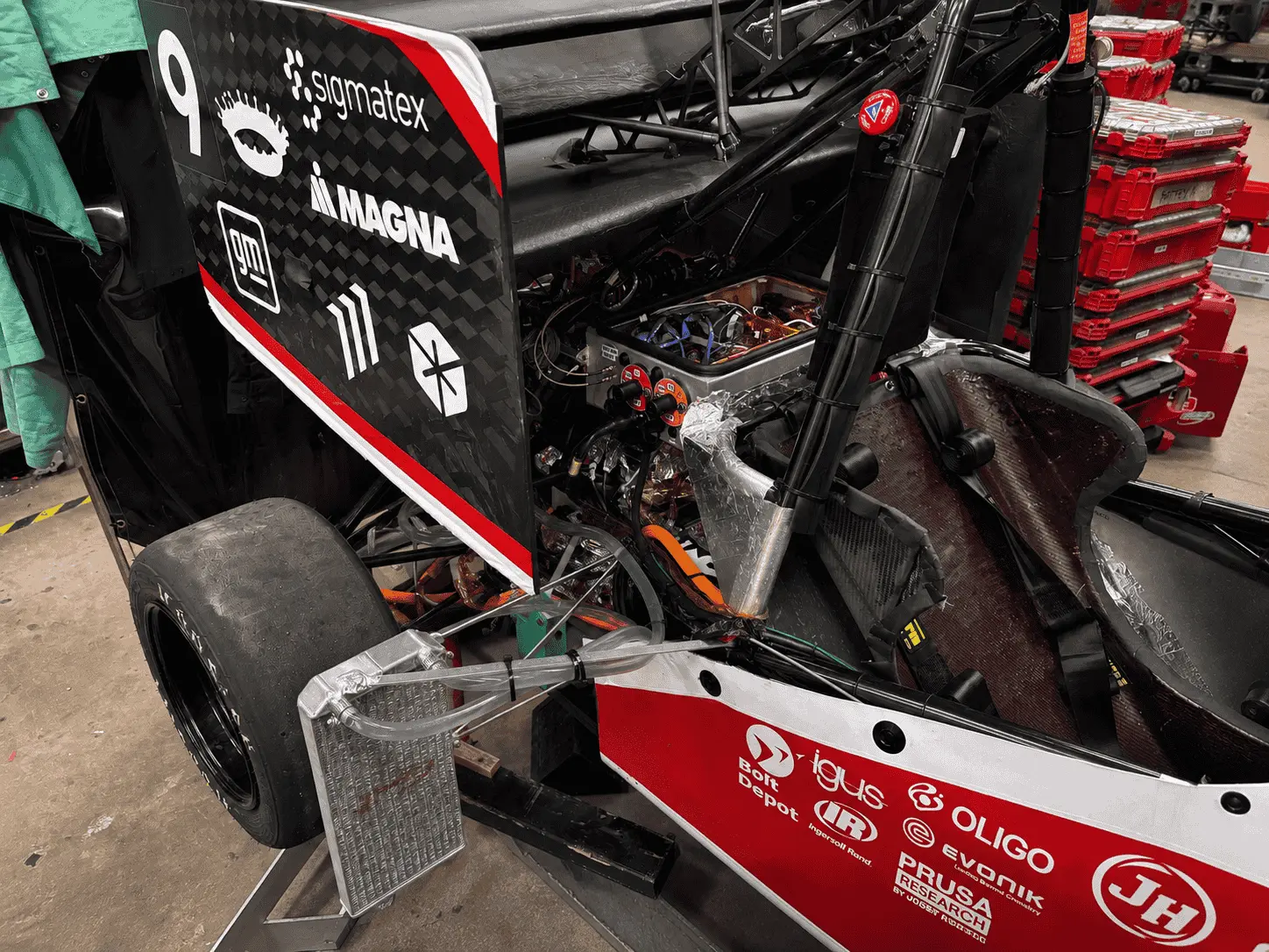Rear of the MIT Motorsports car in the workshop, showing the onboard electronics enclosure