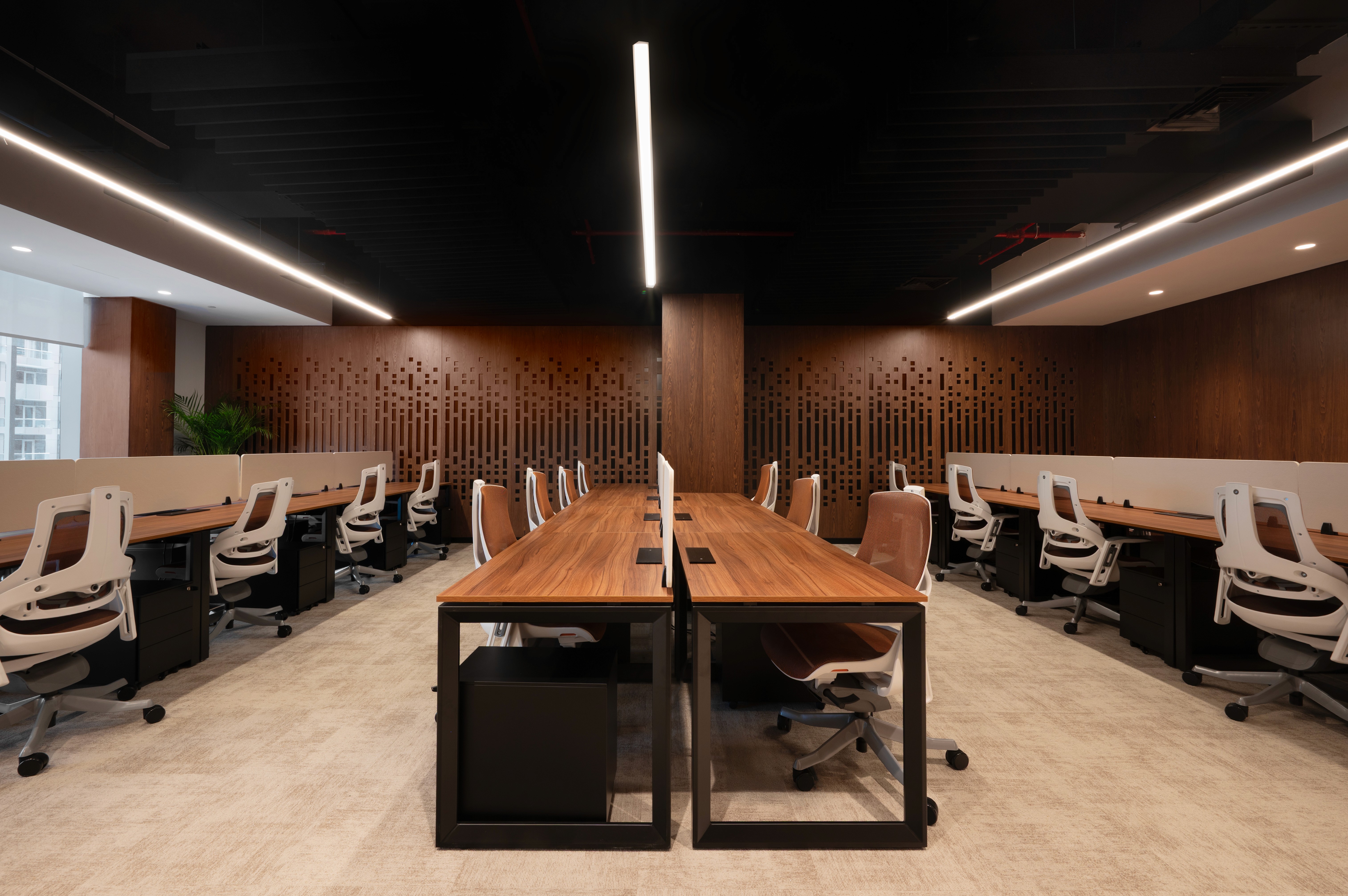 Shared lounge and pantry area with green seating, open coffee station, and a blend of social and workspaces.