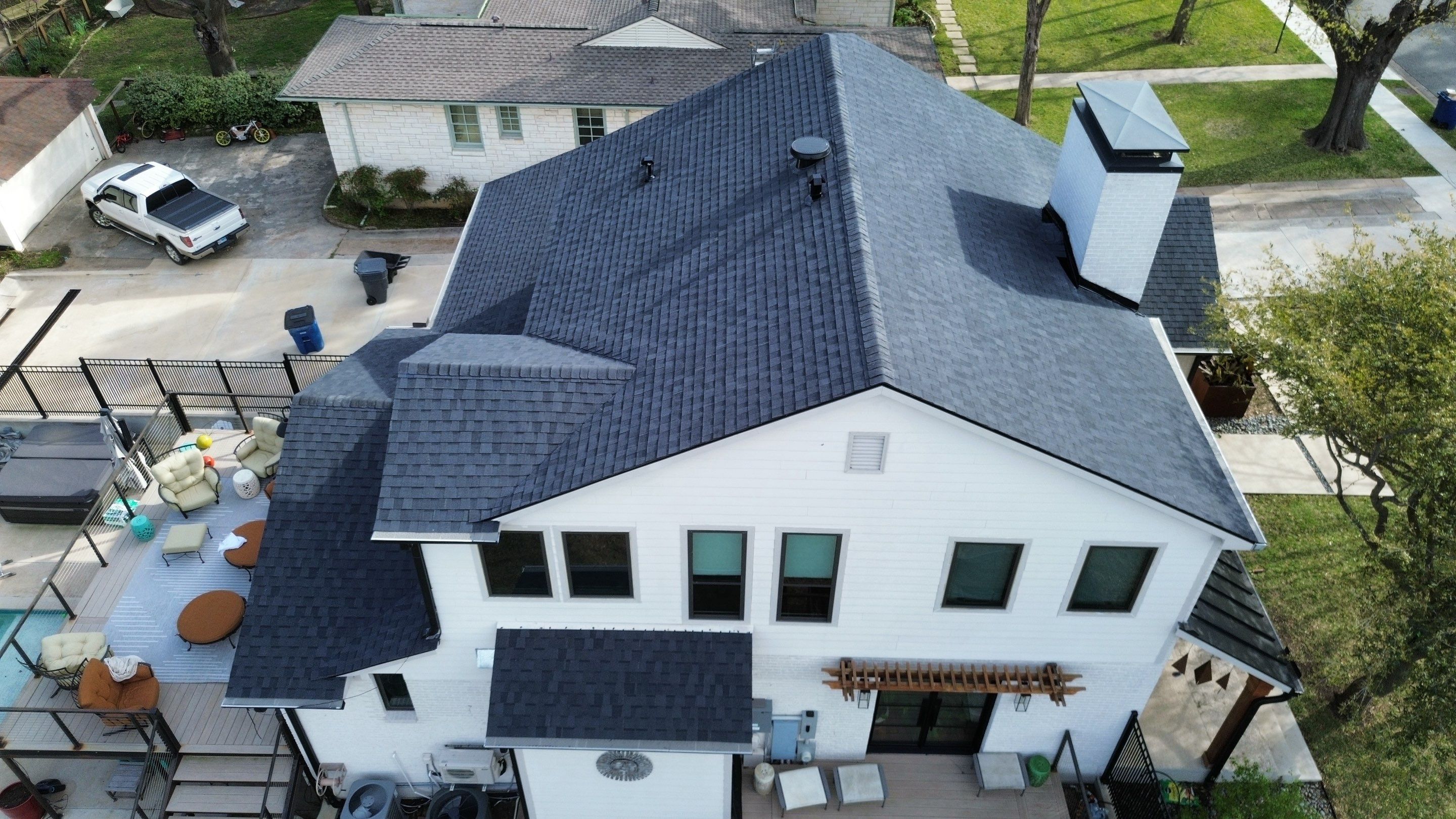Drone aerial of the finished asphalt shingle roof installation on an Oak Cliff home in Dallas