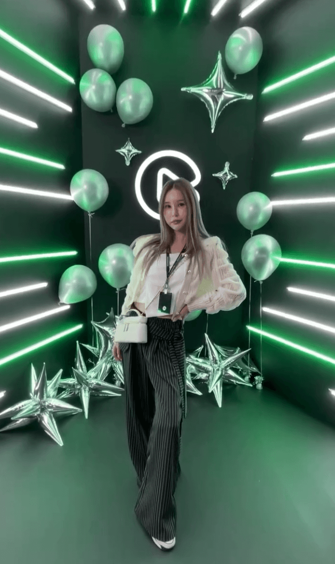 Cluster of translucent pink glass pendant spheres hanging on white—modern lighting décor.