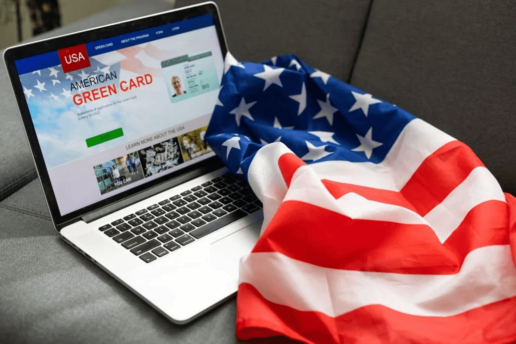 American flag over Green Card website on computer