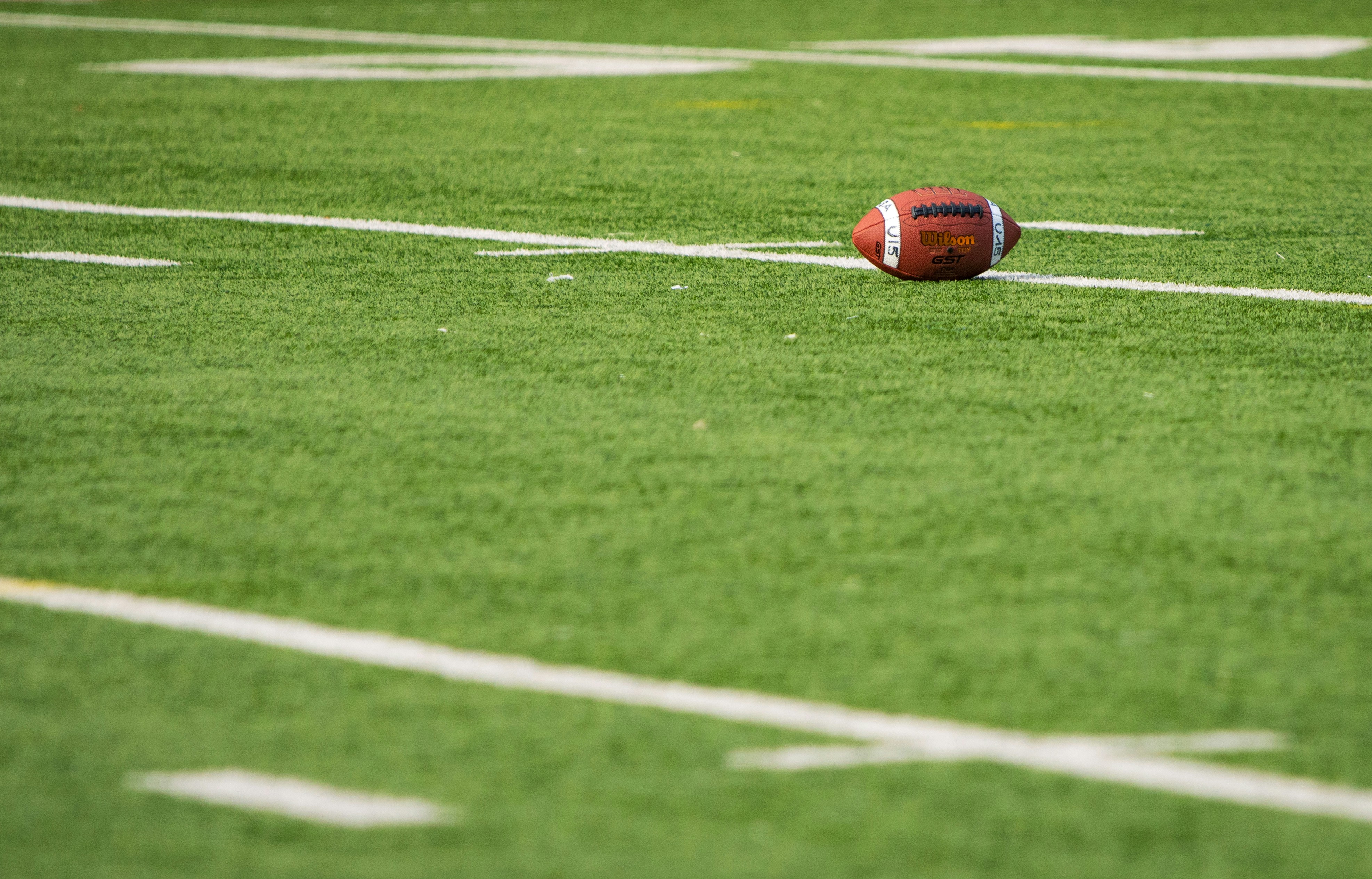 A football laying on a football field