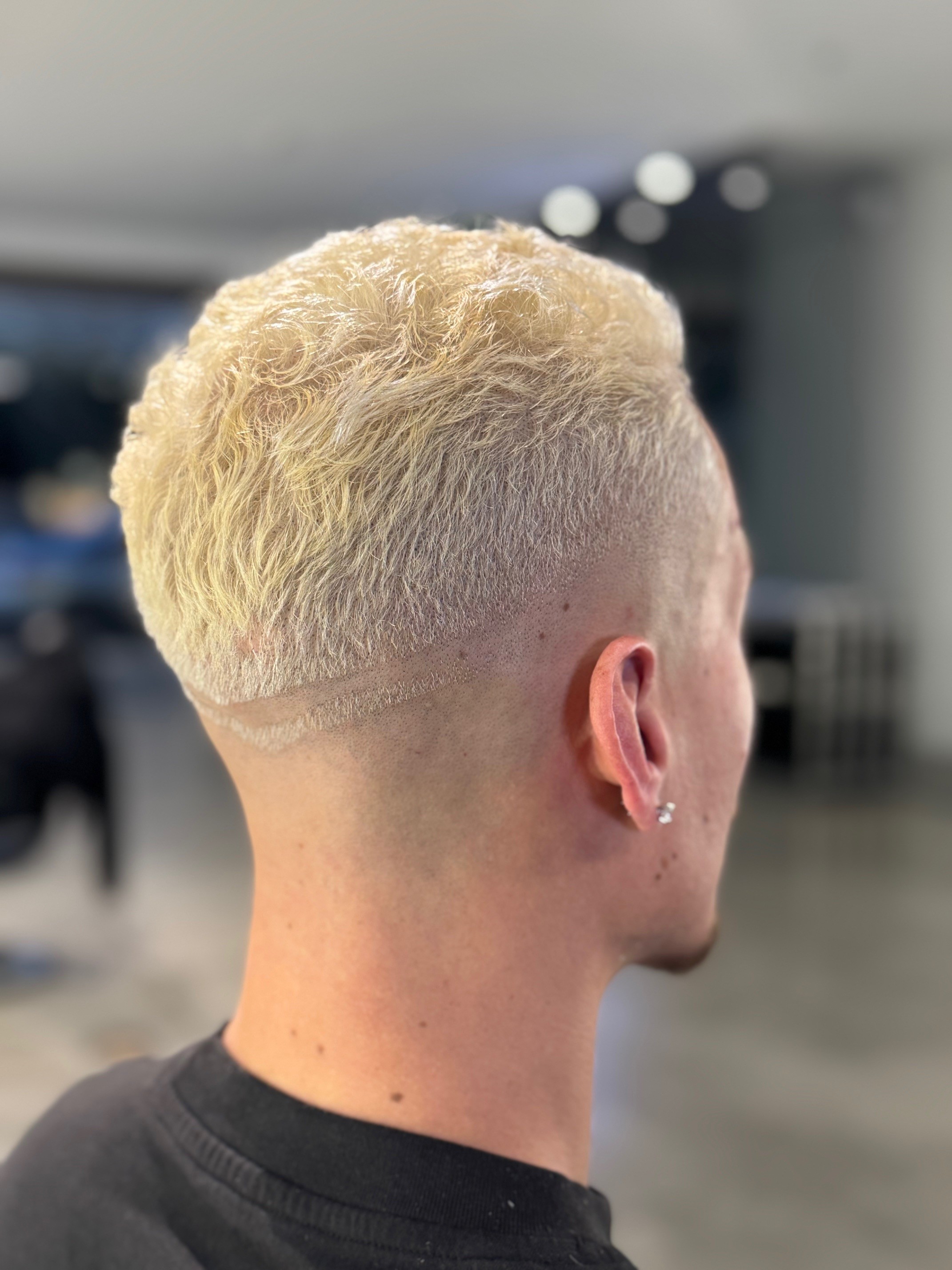 Youthful fade haircut featuring a custom part design, created by Courtney Palmore for a trendy and modern look. The Rich Barber Hair Studio, West Hollywood, CA. Los Angeles