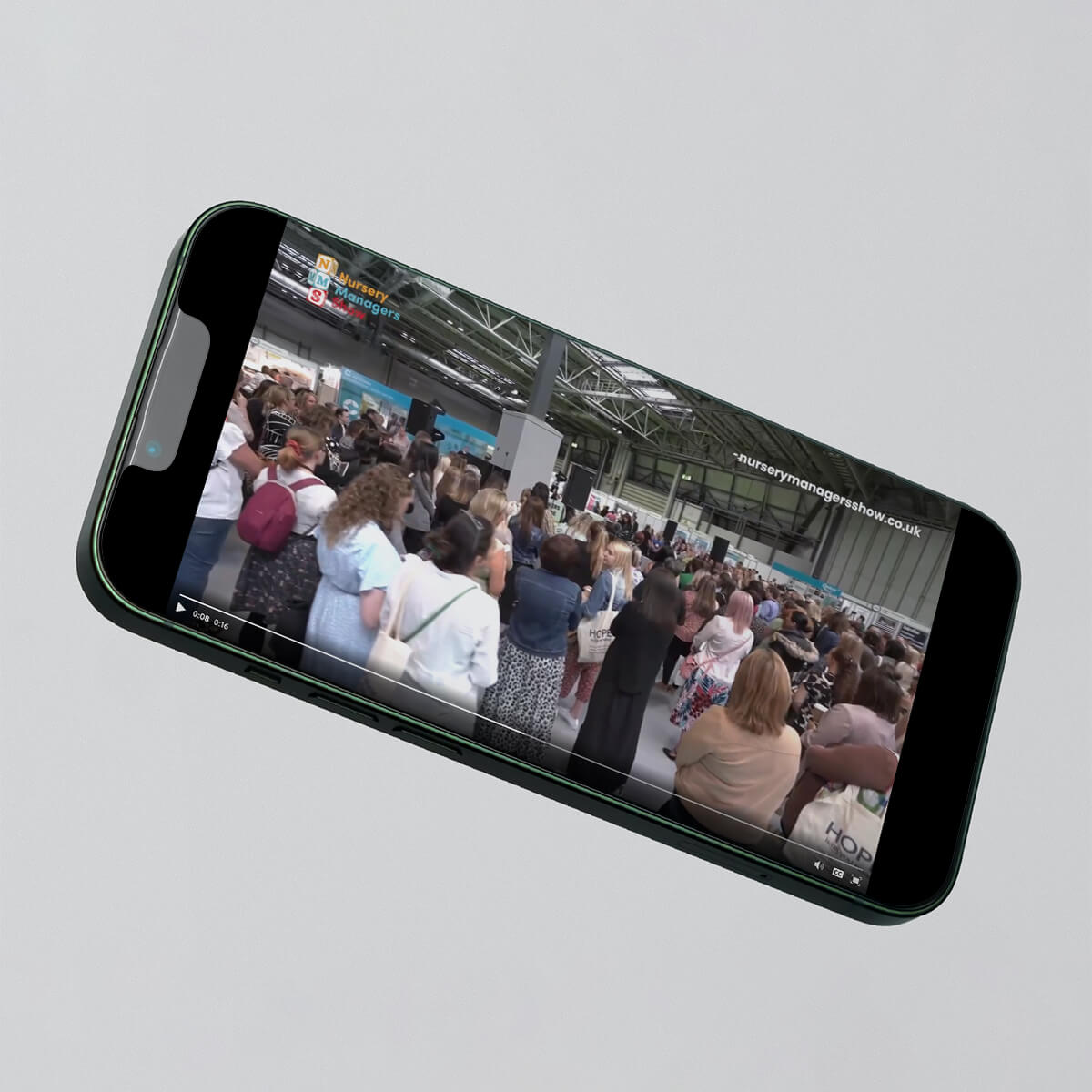 A phone showing a video promo for an event