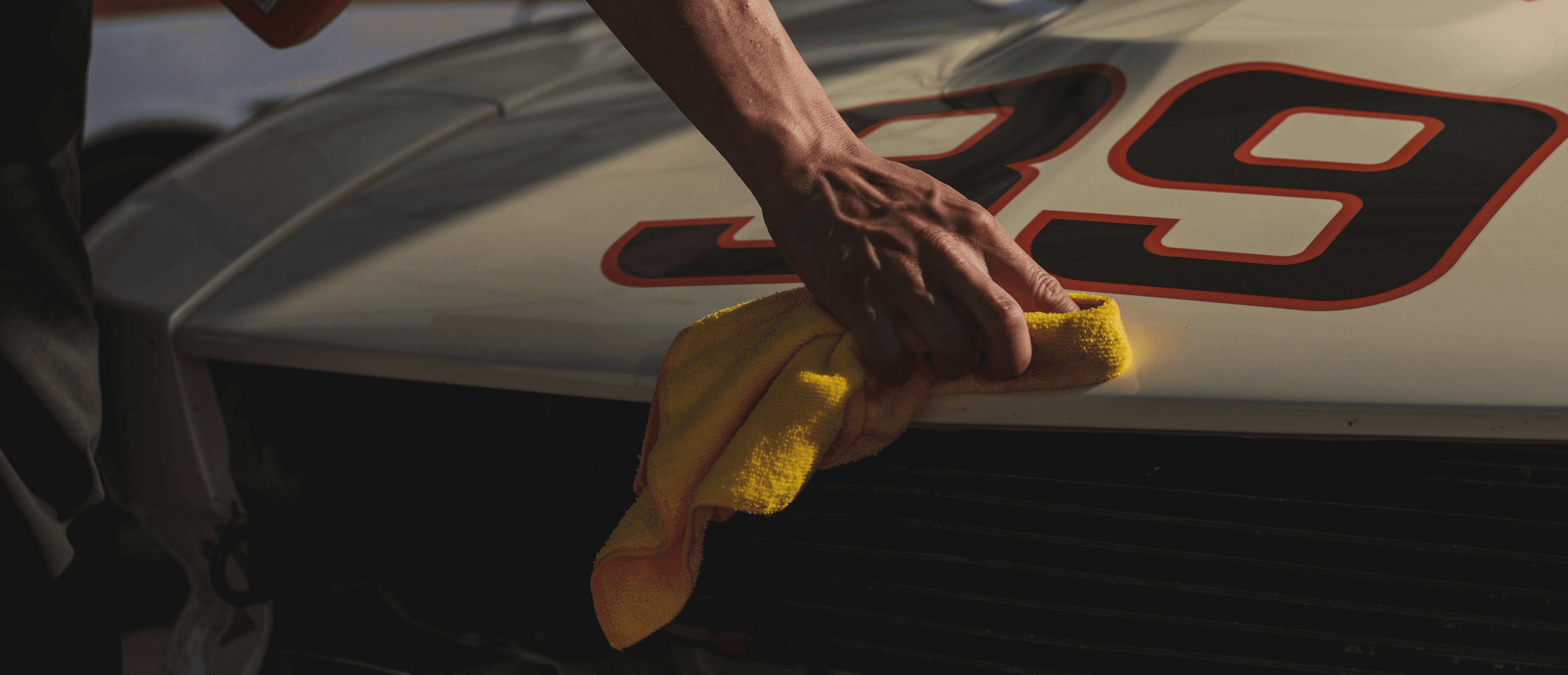 closeup photo of person wiping white racing card