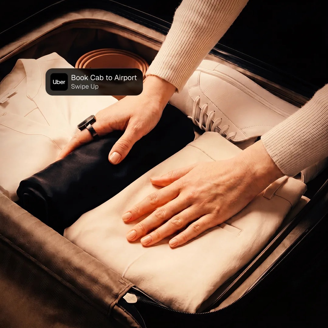 Packing a suitcase with an Uber ride notification