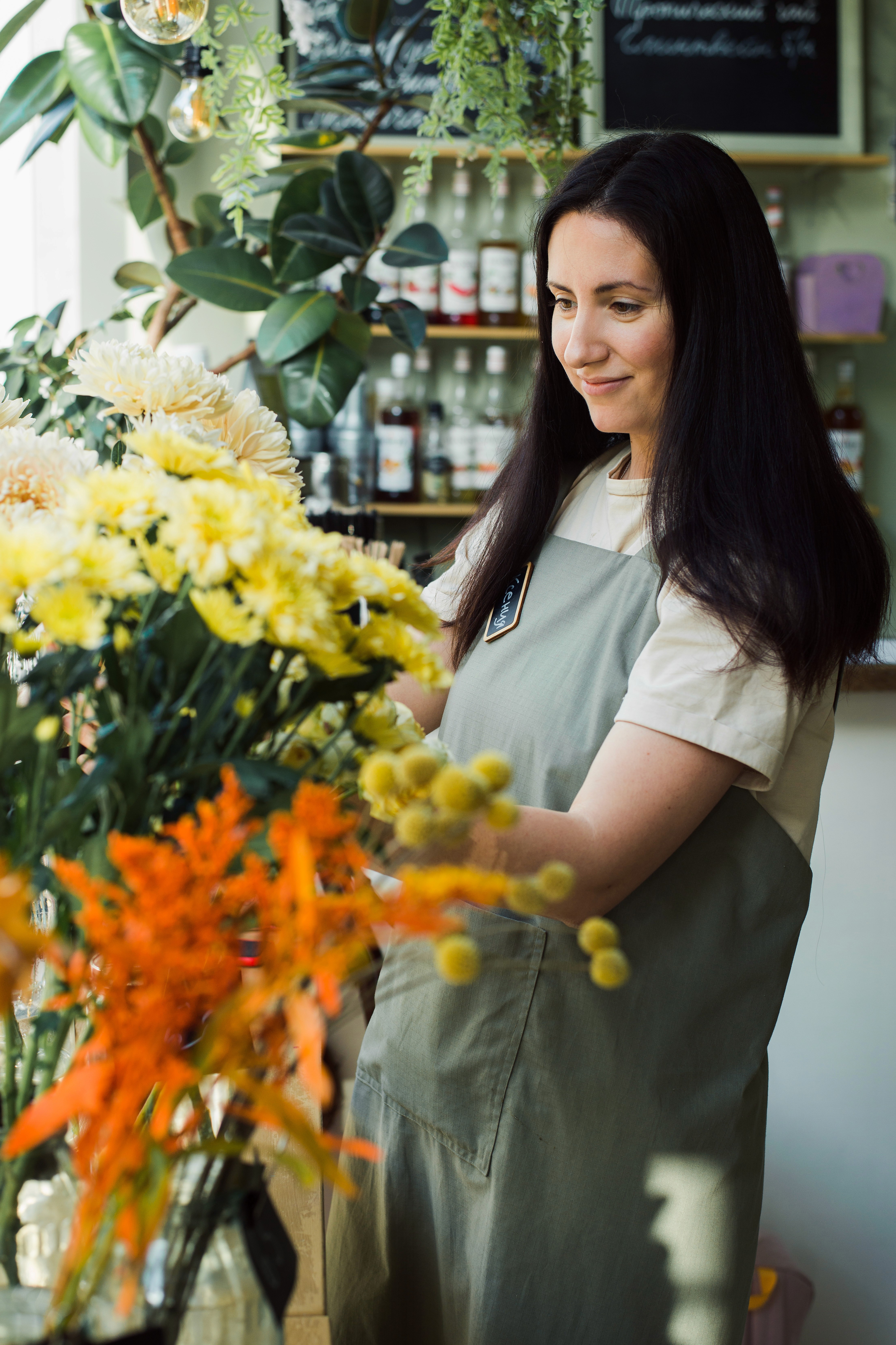 Florist arranging flowers in her shop