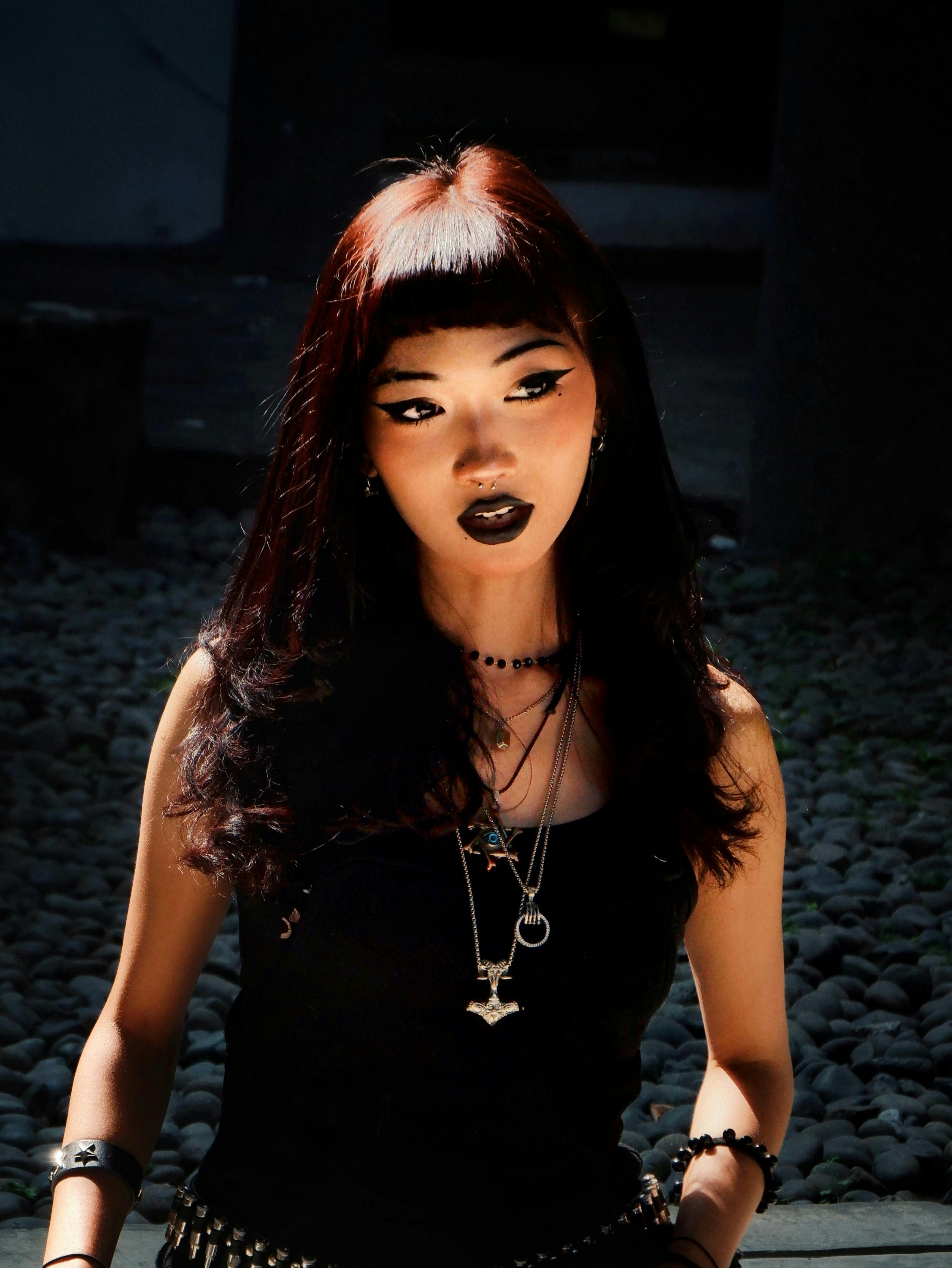 Gothic style portrait of young woman outdoors