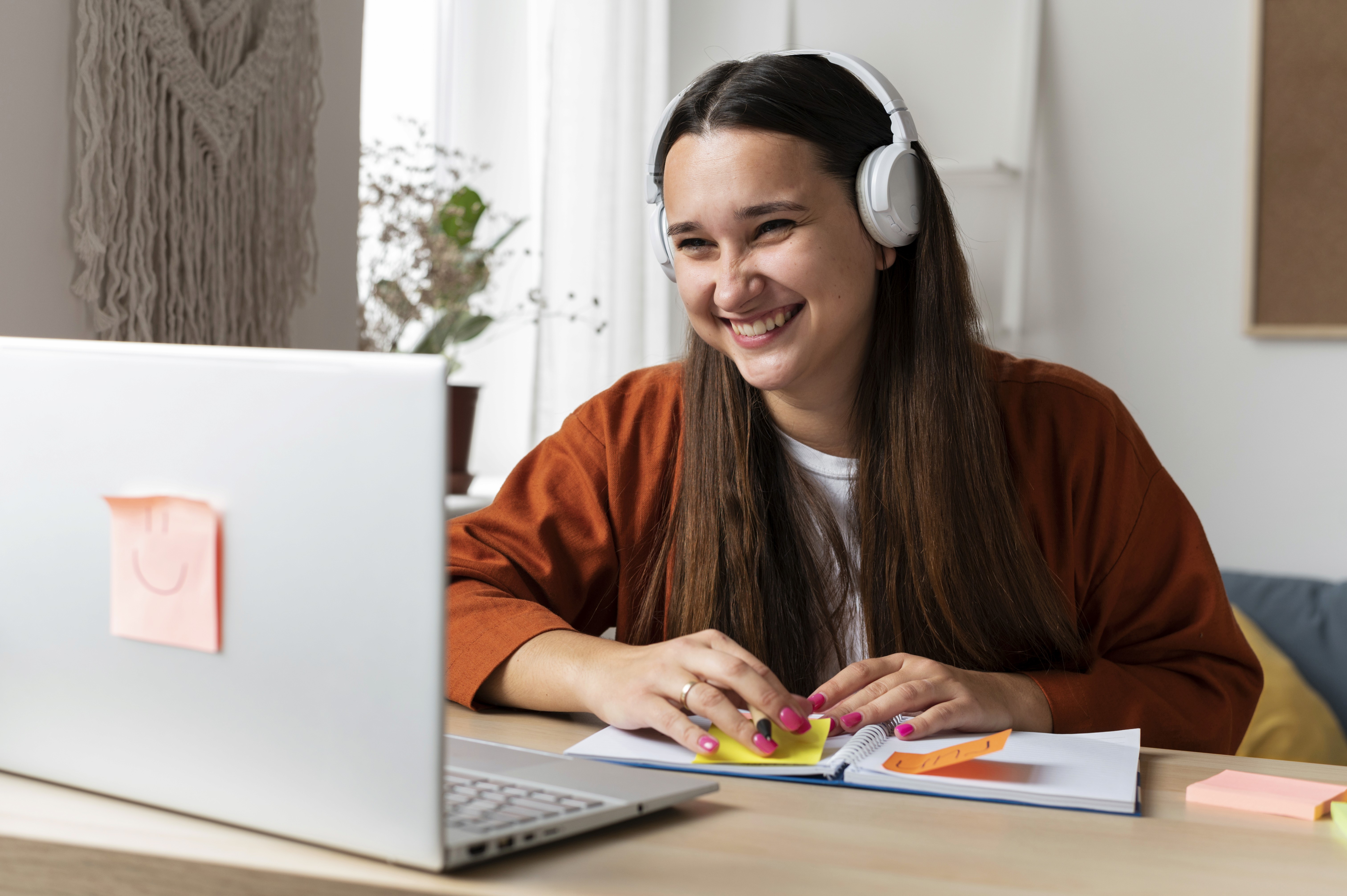 A schoolgirl participates in an online lesson using a tablet