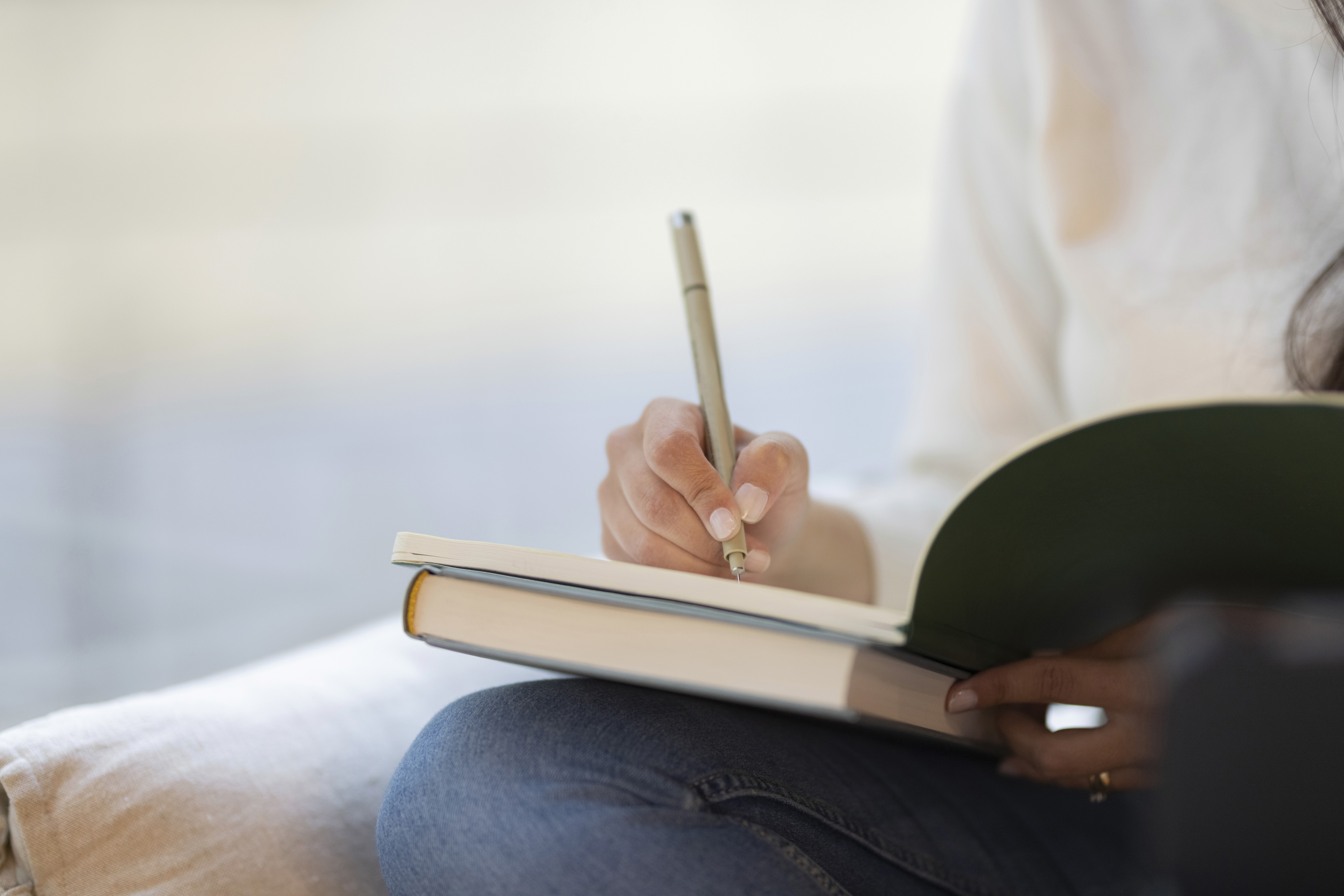 person annotating seizure triggers on diary