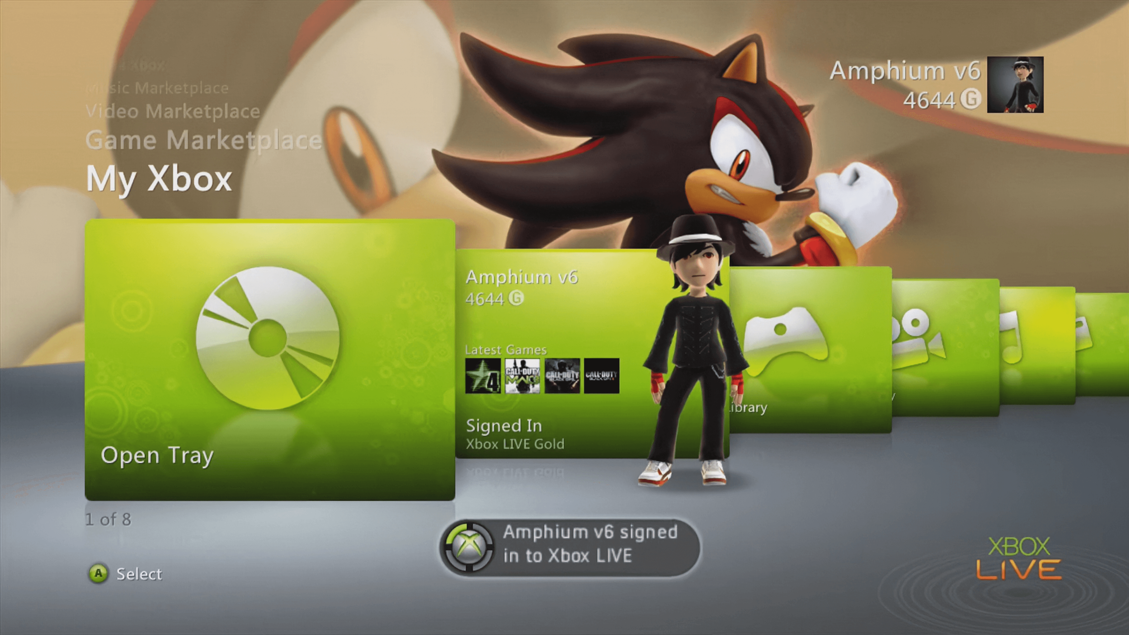The 'My Xbox' menu on an Xbox 360 console display. The screen shows green curved menu tiles, an 'Open Tray' icon, and a user avatar in a black suit. A large graphic of Shadow the Hedgehog from the Sonic series serves as the background wallpaper.