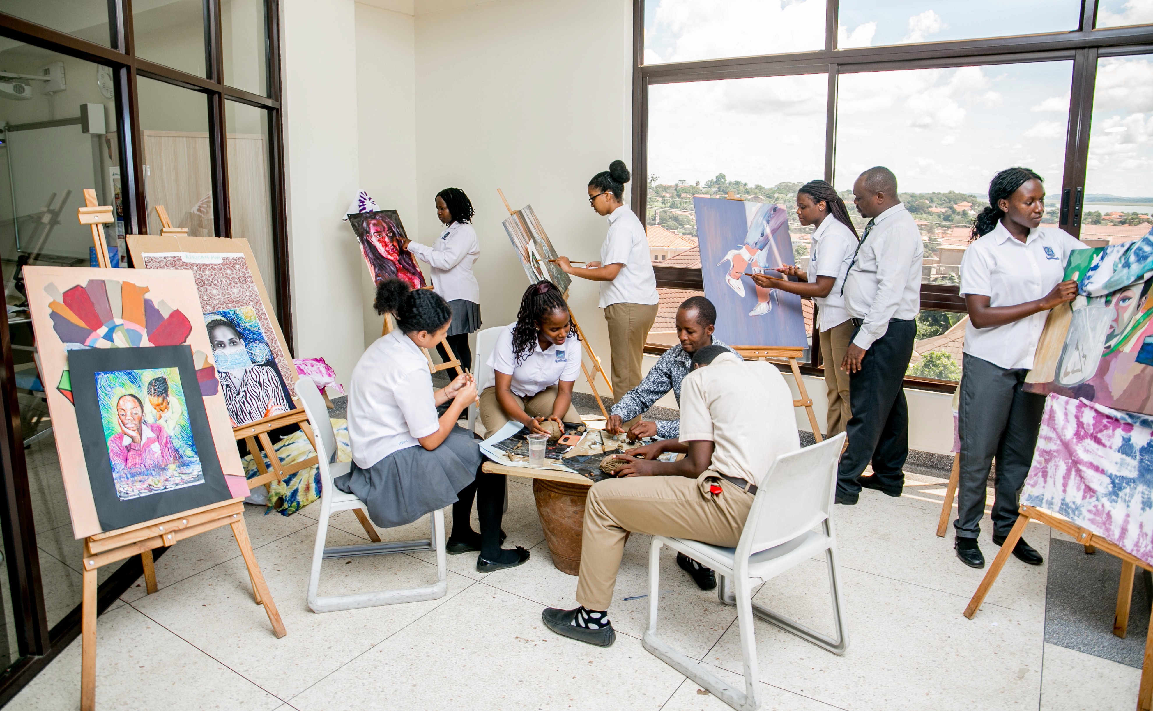 Children are sitting on the grass, reading a book together
