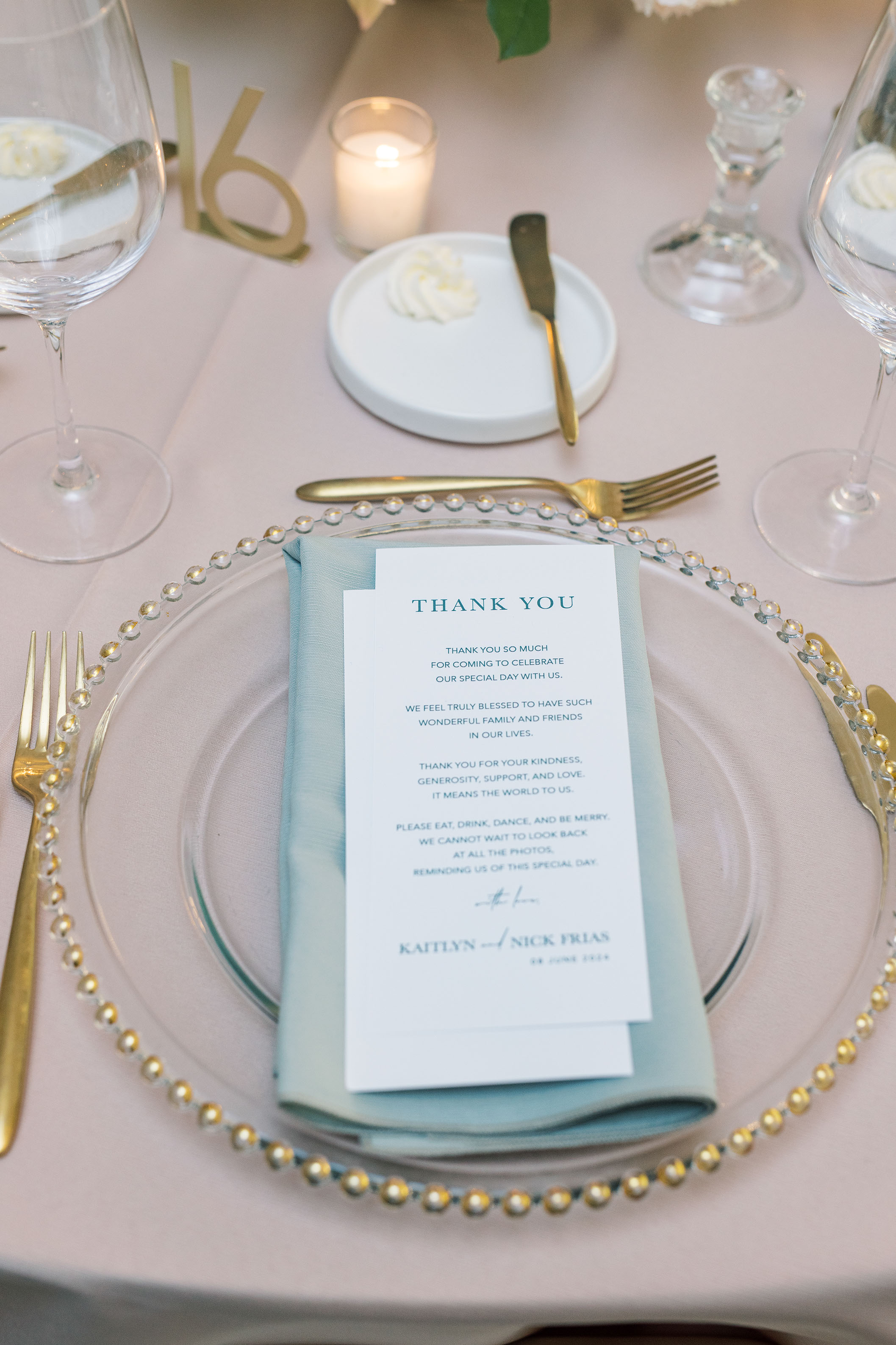 Place setting with a thank-you note and gold table number at the reception.