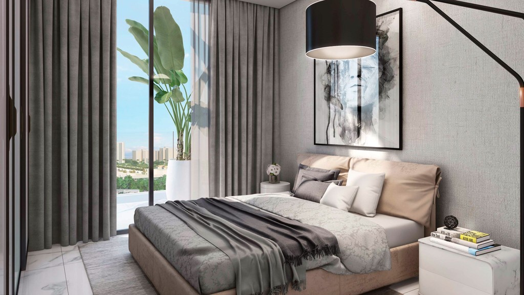 A modern bedroom featuring a large bed and a spacious window allowing natural light to fill the room.