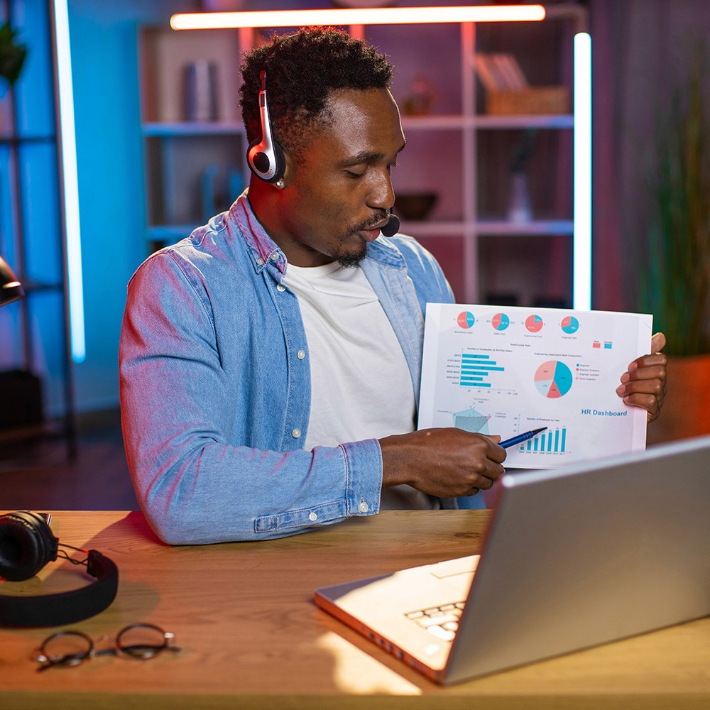 Professional reviewing a sales growth chart on laptop