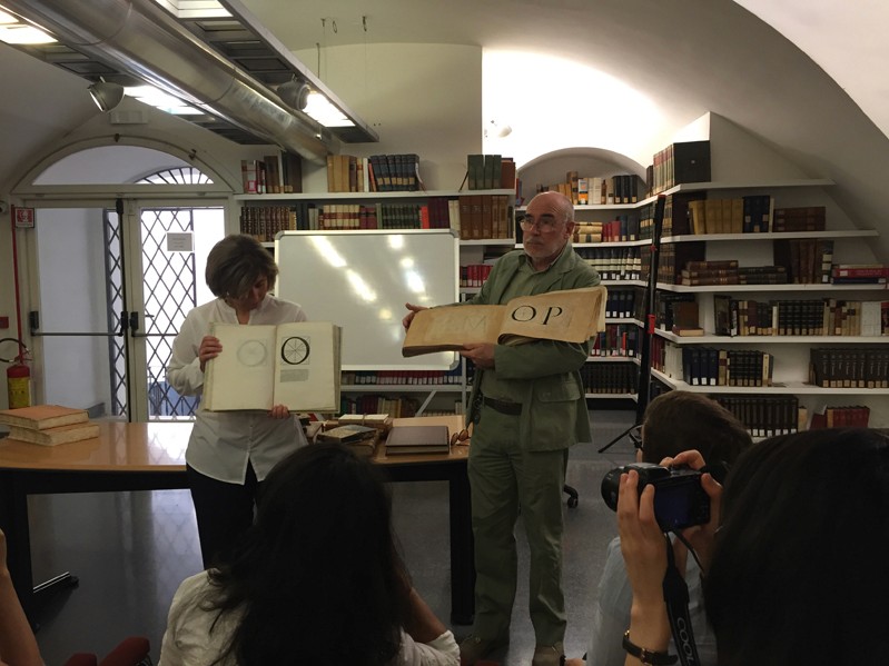 two teachers holding books at class