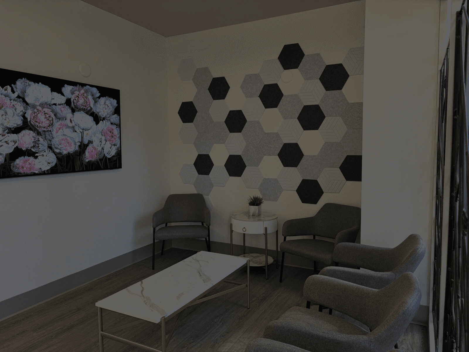 A cozy waiting area at Metro Pointe Dental featuring comfortable chairs, a small table, and decorative wall art, creating a welcoming atmosphere for patients.