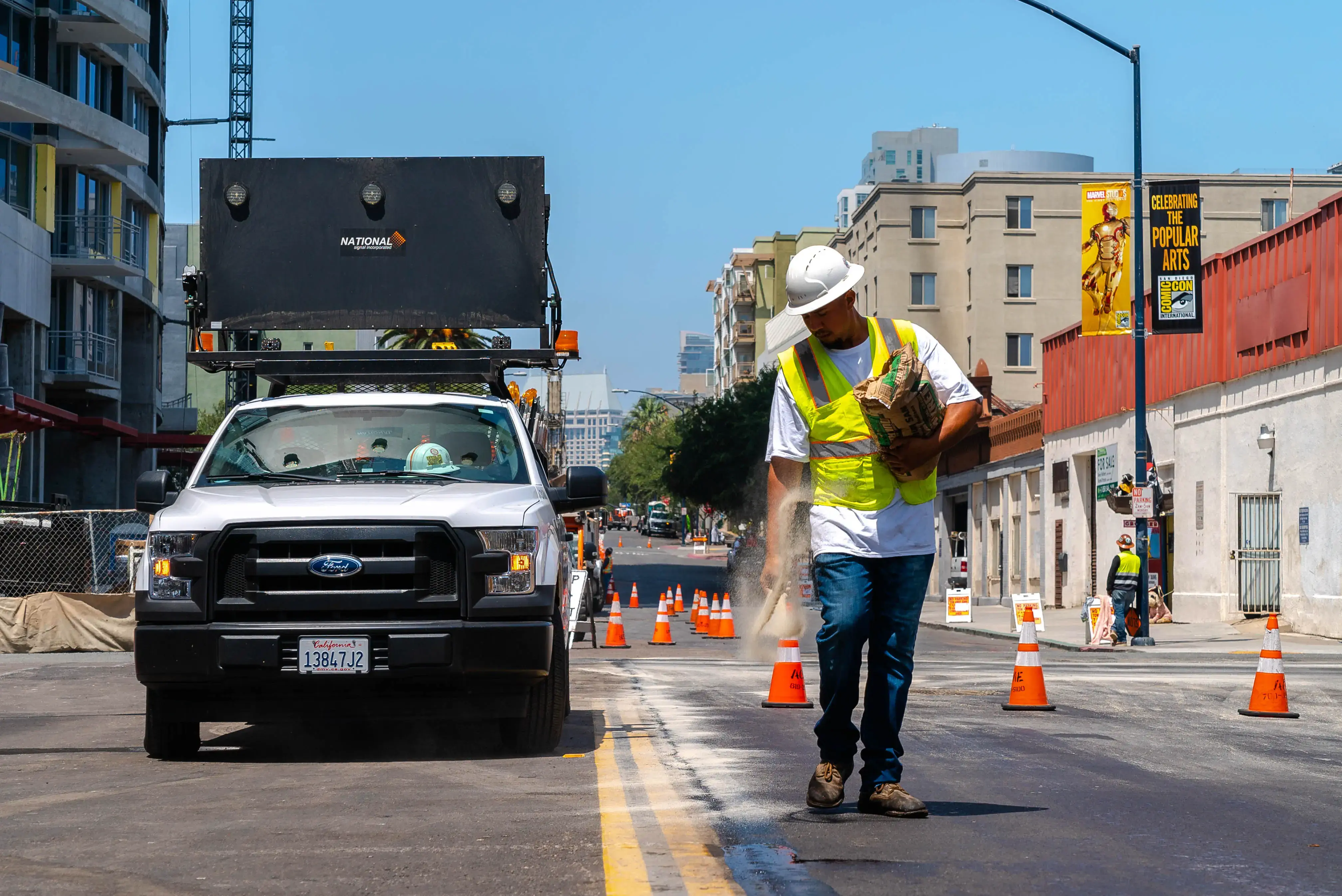 Truck and construction worker on city streets project