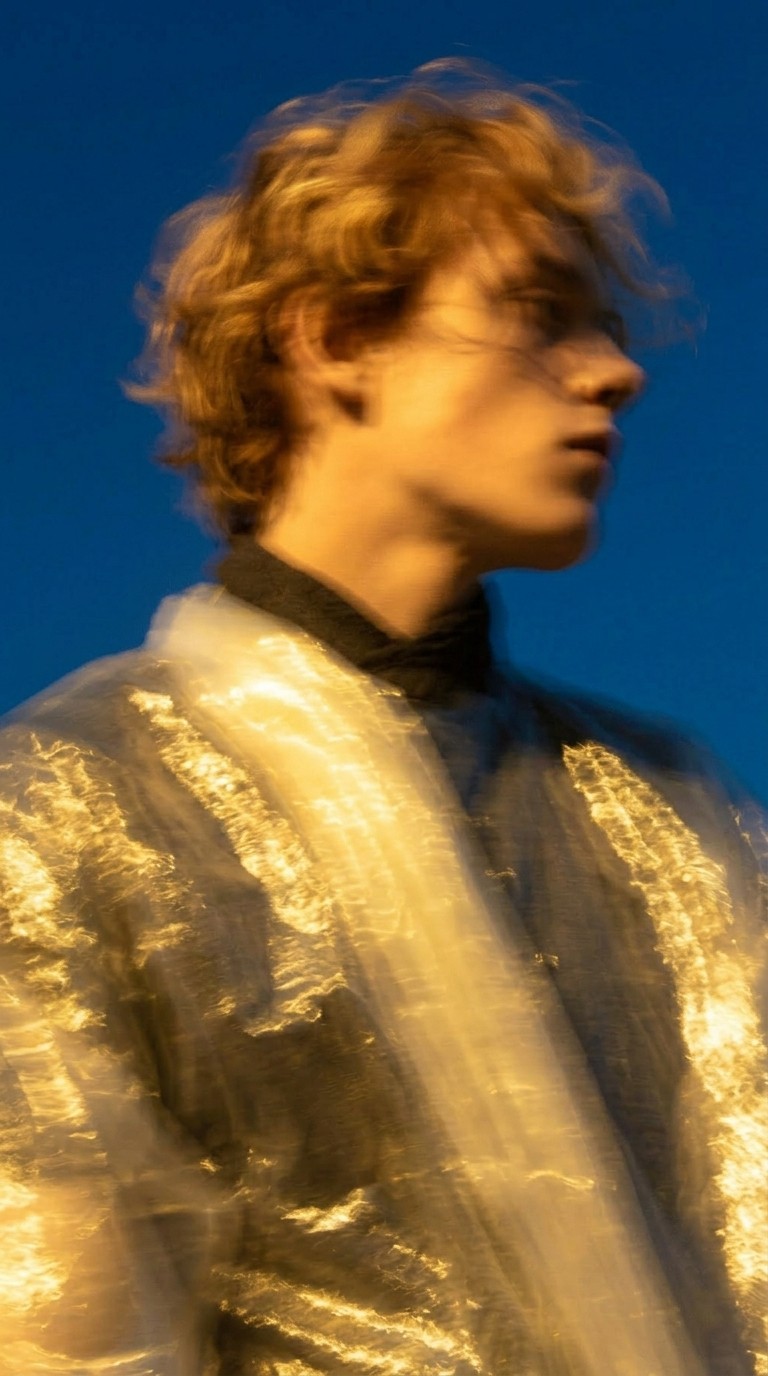 Profile shot of a man in reflective clothing with clear sky background
