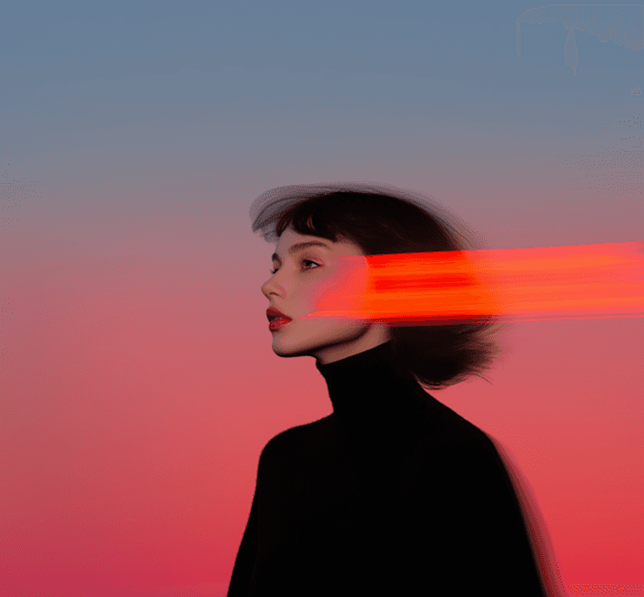 A woman with vibrant red hair is illuminated by a red light, enhancing her features and the surrounding atmosphere.