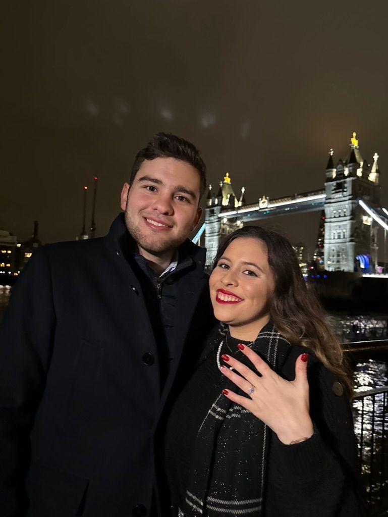 A bride and groom share a kiss, enveloped in the bride's flowing veil. The soft focus and gentle light convey a romantic, intimate atmosphere.